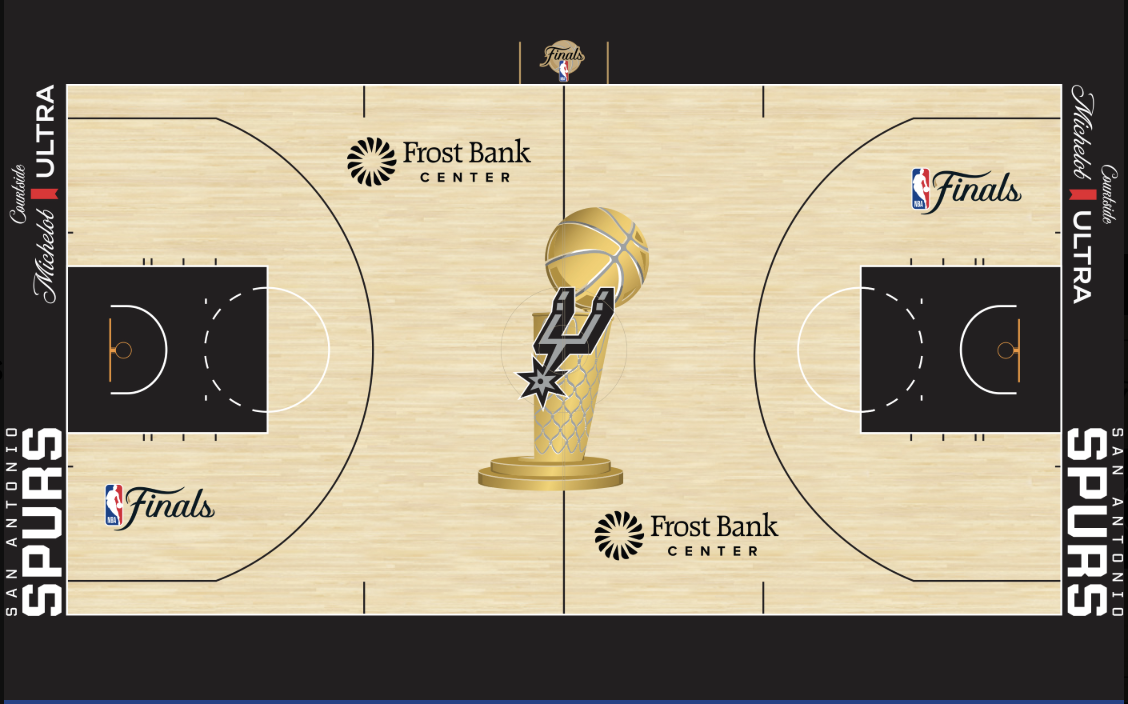 San Antonio Spurs 2026 NBA Finals court design at Frost Bank Center with natural hardwood floor, SAN ANTONIO SPURS wordmark in black running vertically along both baselines, Frost Bank Center sponsor logo on both sidelines, the Larry O'Brien Trophy painted at center court with the Spurs primary spurs mark embedded inside the trophy silhouette, The Finals cursive script logo painted in both keys, and the new NBA Finals logo painted on the sideline directly above center court