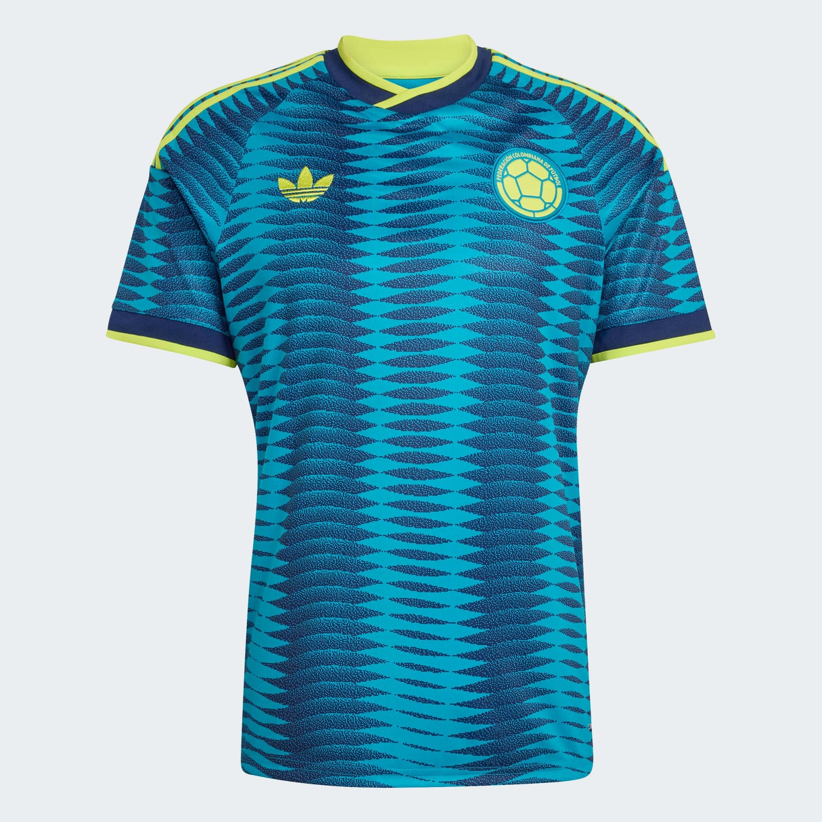 Colombia 2026 World Cup adidas teal and navy change jersey with a tonal chevron pattern and yellow trim, worn in the Group K match vs Uzbekistan