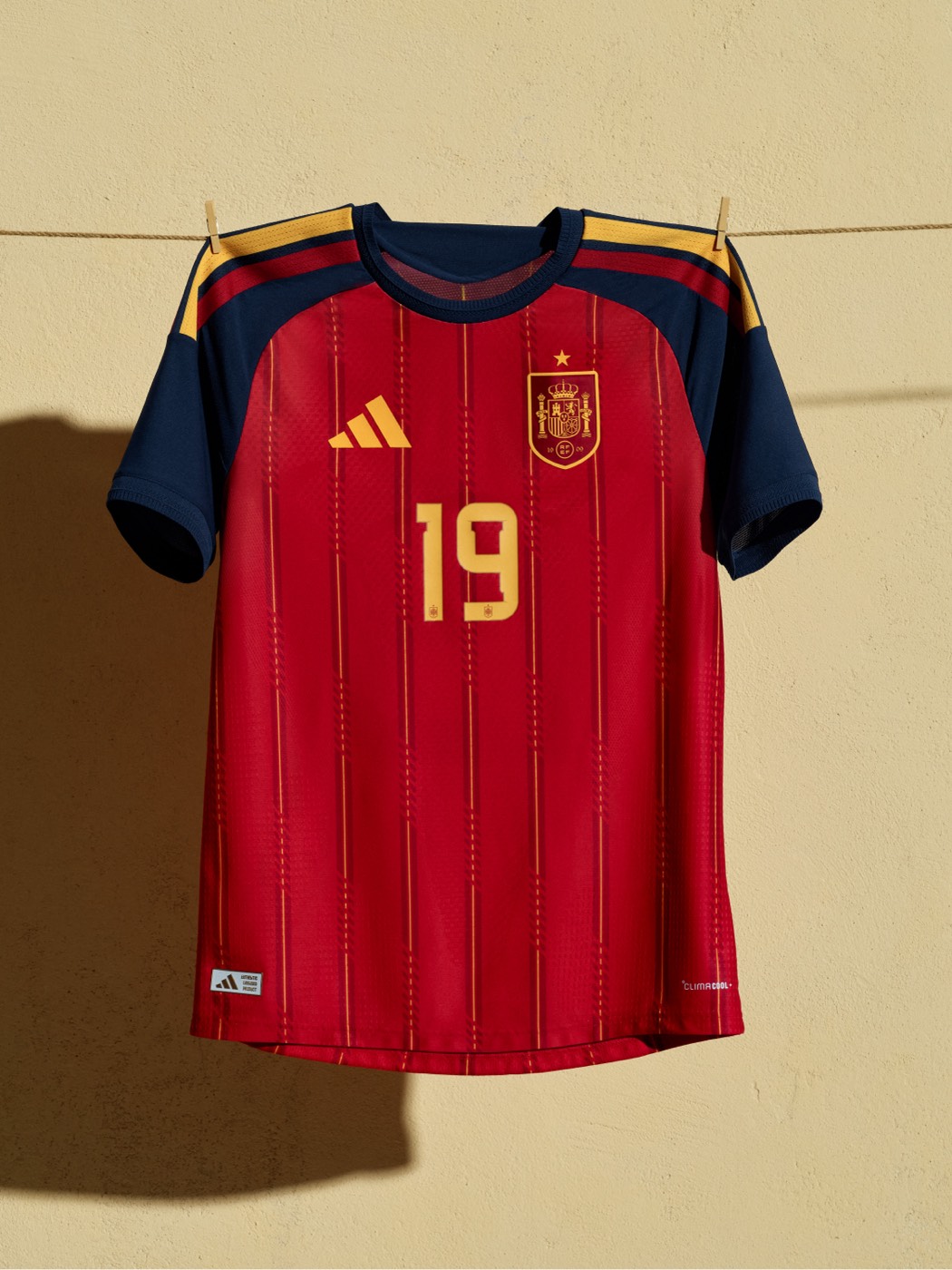 Spain 2026 World Cup home kit by Adidas in red with gold pinstripes