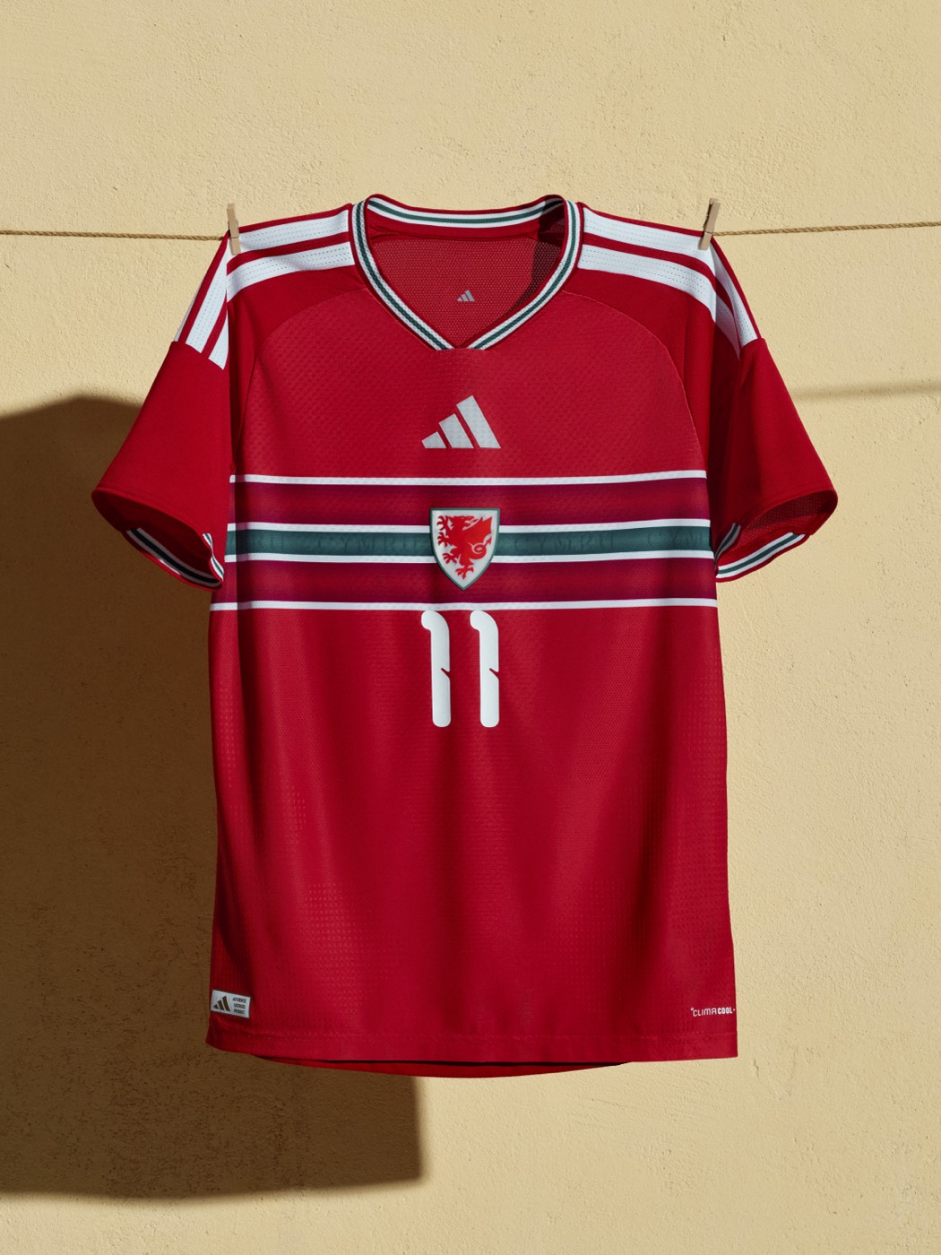 Wales 2026 World Cup home kit by Adidas in red with horizontal stripes