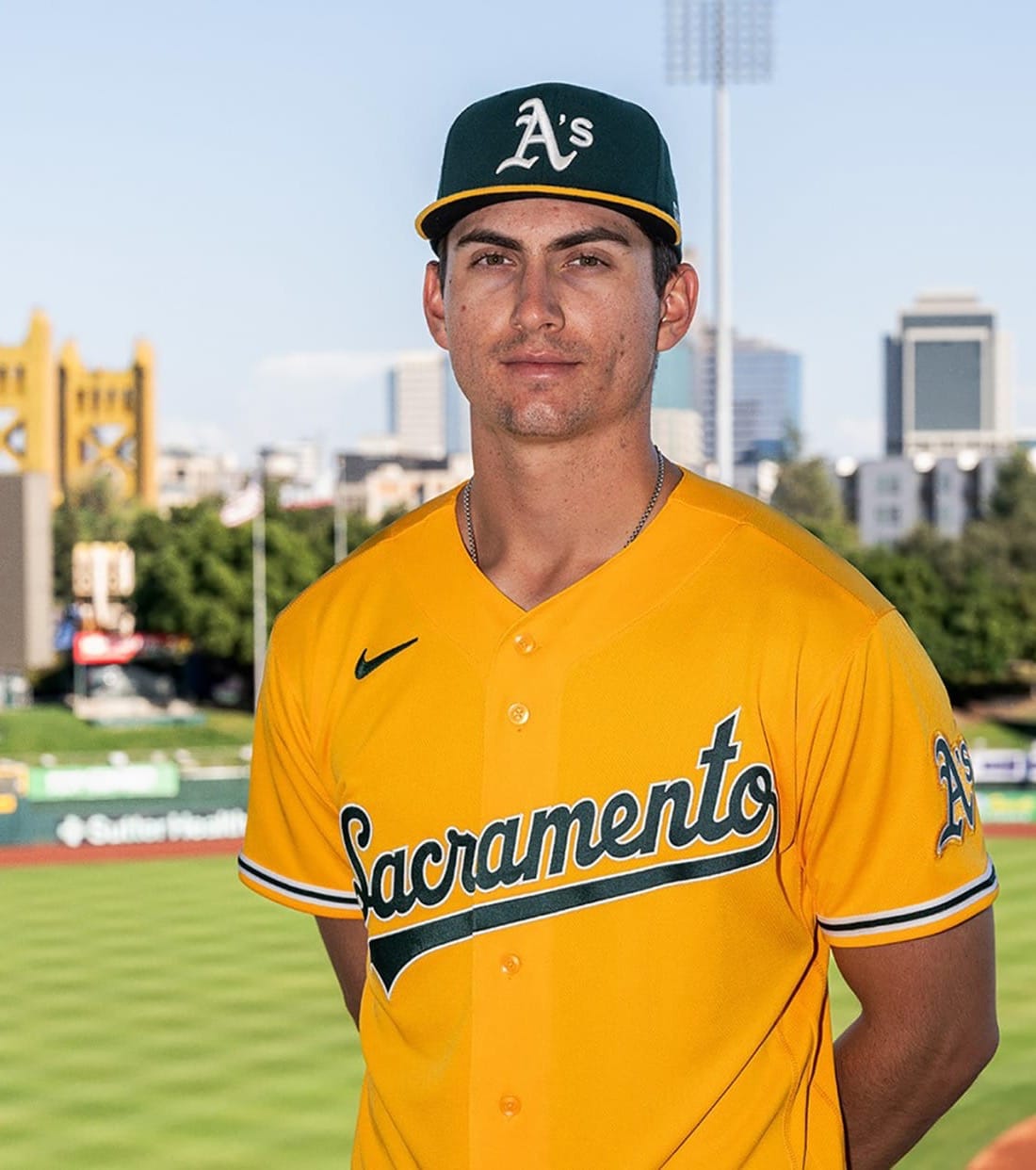 Athletics 2026 gold Sacramento alternate jersey, gold with Sacramento in green script across the chest and the green A's cap, worn for Sacramento Saturdays at Sutter Health Park