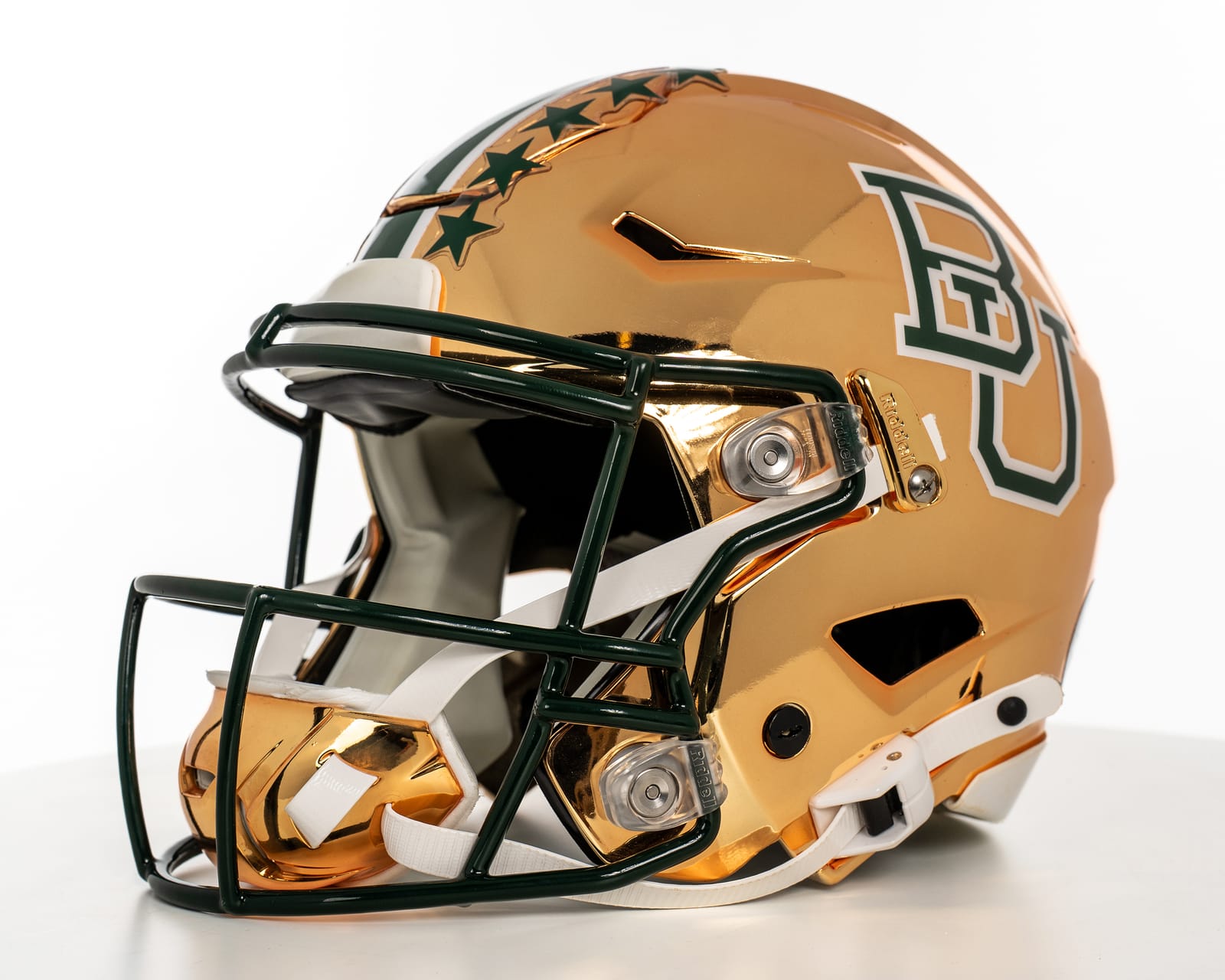 Baylor 2026 gold chrome throwback helmet, a gold chrome shell with a green center stripe, green stars along the stripe, a green interlocking BU on the side and a green facemask
