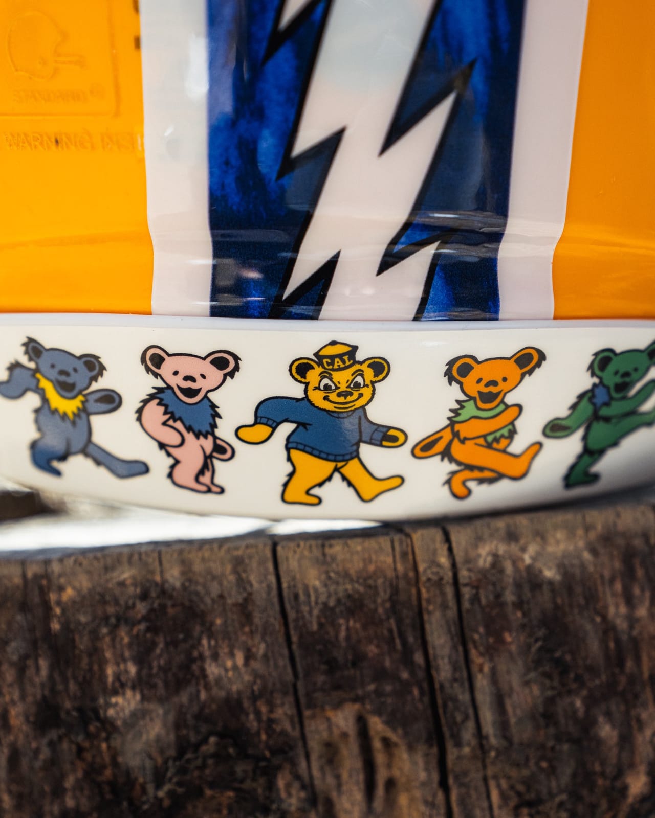 Grateful Dead dancing bears and Oski in a CAL sweater on the rear bumper of the Cal helmet