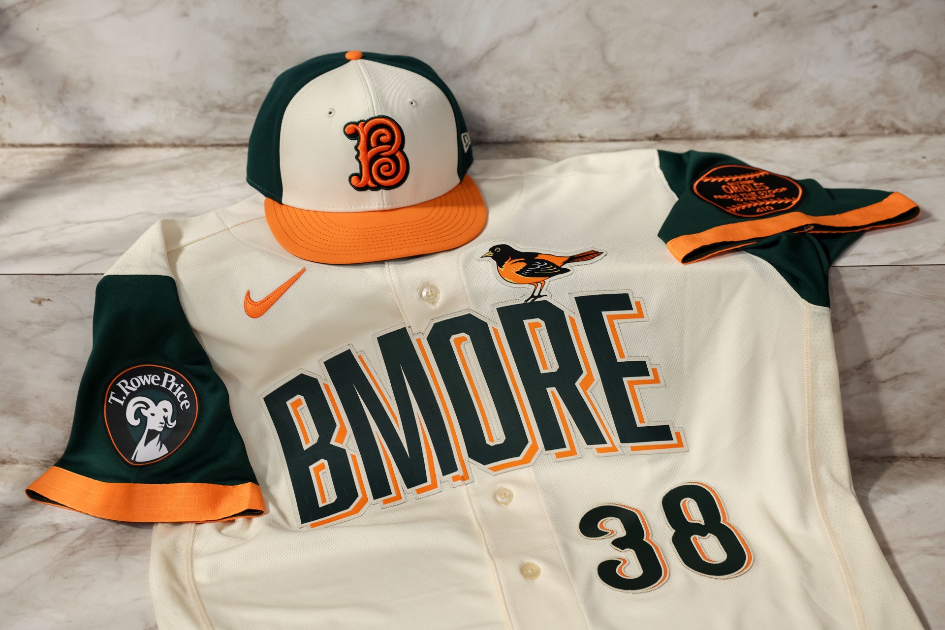 Baltimore Orioles 2026 City Connect BMORE jersey and hat flat lay