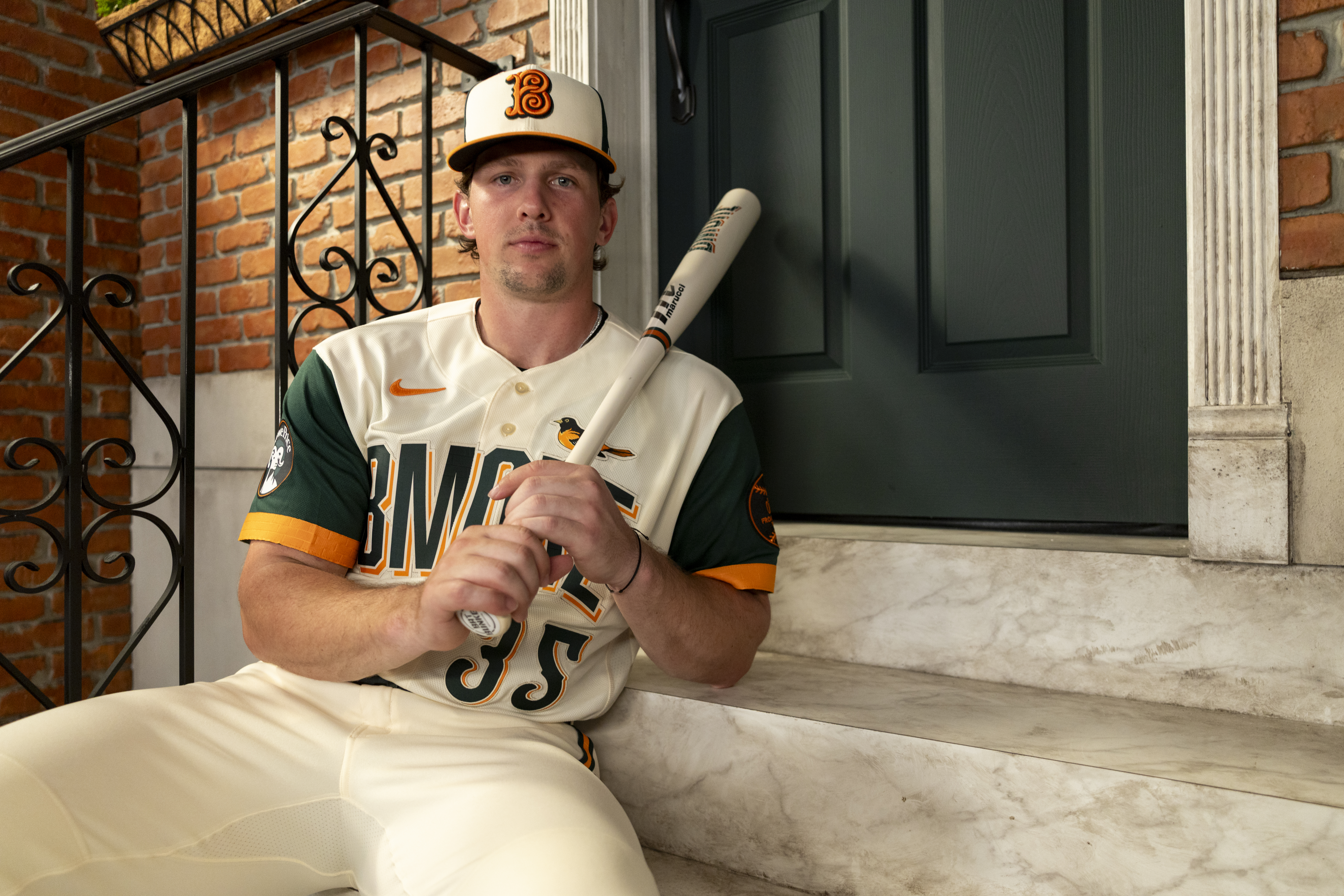 Baltimore Orioles player sitting on stoop in 2026 City Connect uniform