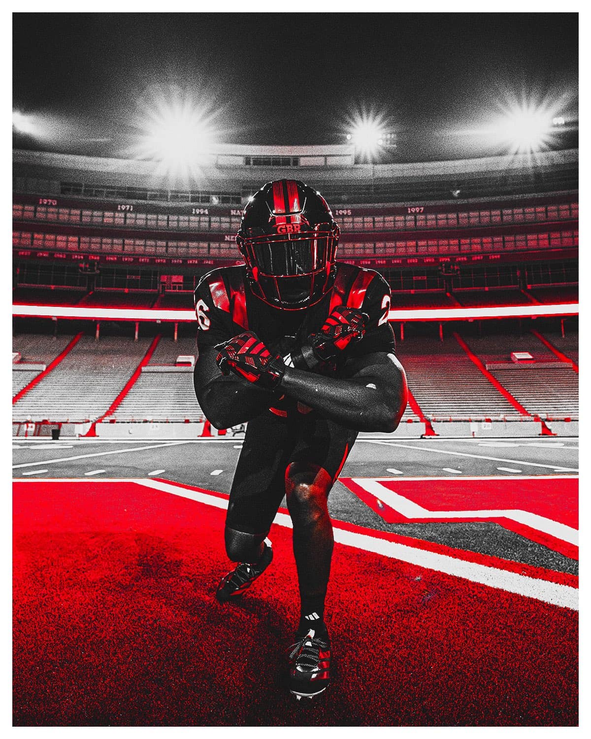 Nebraska player in the 2026 blackout uniform standing on the Memorial Stadium field under the lights
