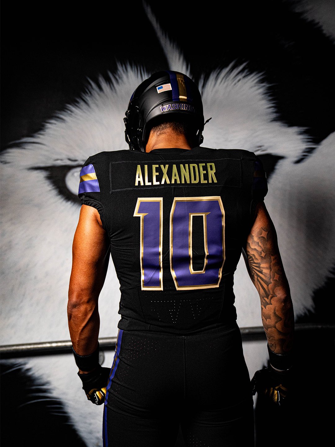 Back of the Washington 2026 black alternate uniform showing the gold ALEXANDER nameplate and a purple number 10 with gold outline