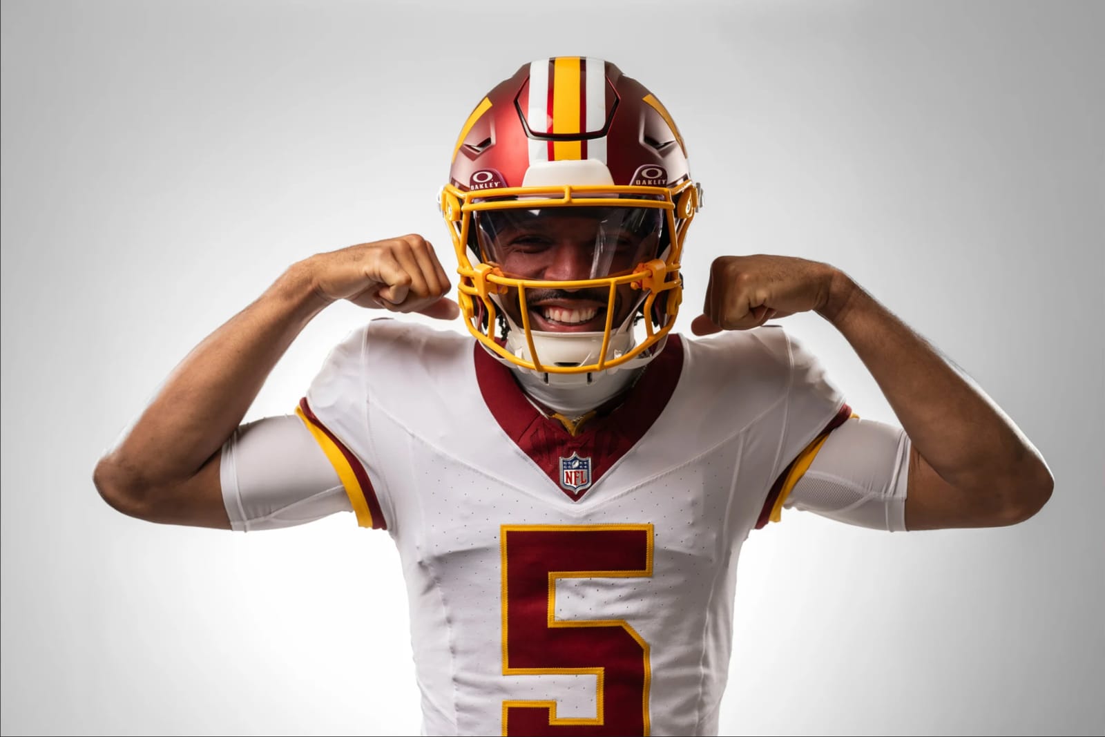Jayden Daniels smiling in Washington Commanders throwback uniform