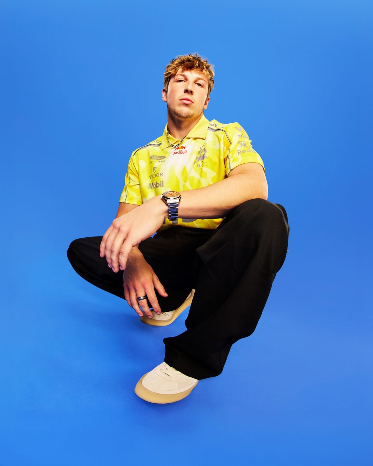 Visa Cash App RB F1 driver in a yellow Hugo team polo with Tudor Mobil and Red Bull sponsor branding ahead of the 2026 Miami Grand Prix Summer Edition reveal earlier in the race week