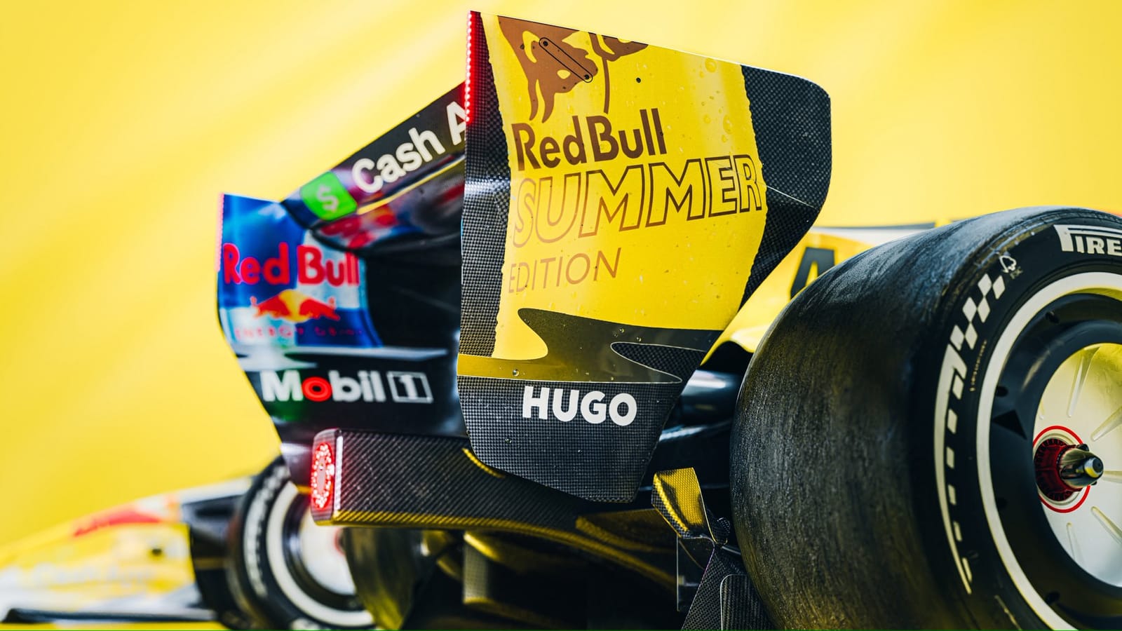 Visa Cash App RB Summer Edition Miami GP 2026 close-up detail of the rear wing reading Red Bull Summer Edition in a sun-warmed gold treatment with Cash App and Hugo logos in their usual contrasting colors against the deep yellow base