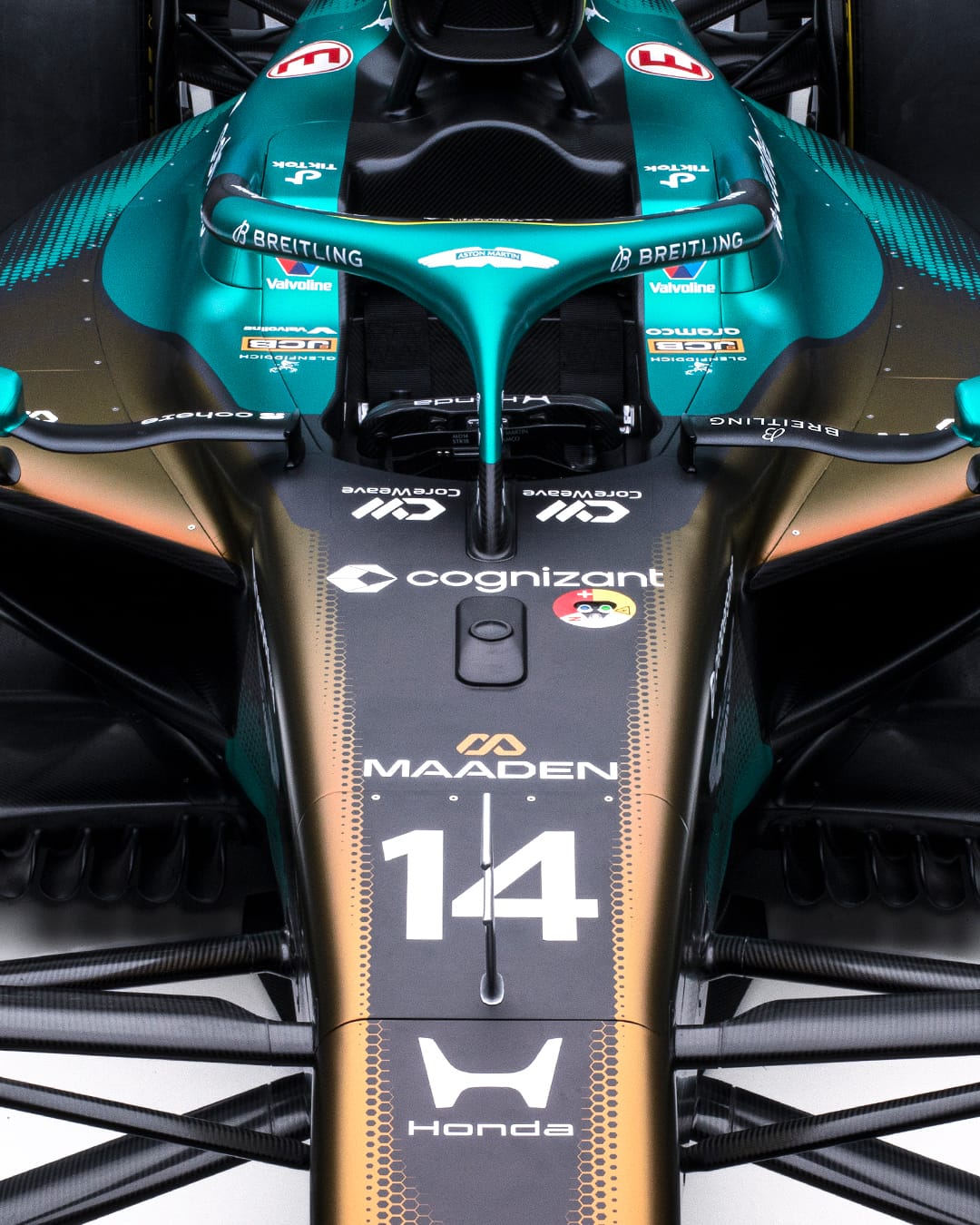 Aston Martin AMR25 F1 Monaco Grand Prix 2026 Maaden iridescent livery overhead view of the nose and front chassis showing the number 14 of Fernando Alonso under the MAADEN wordmark and the iridescent green-to-gold hexagonal pattern across the nose section