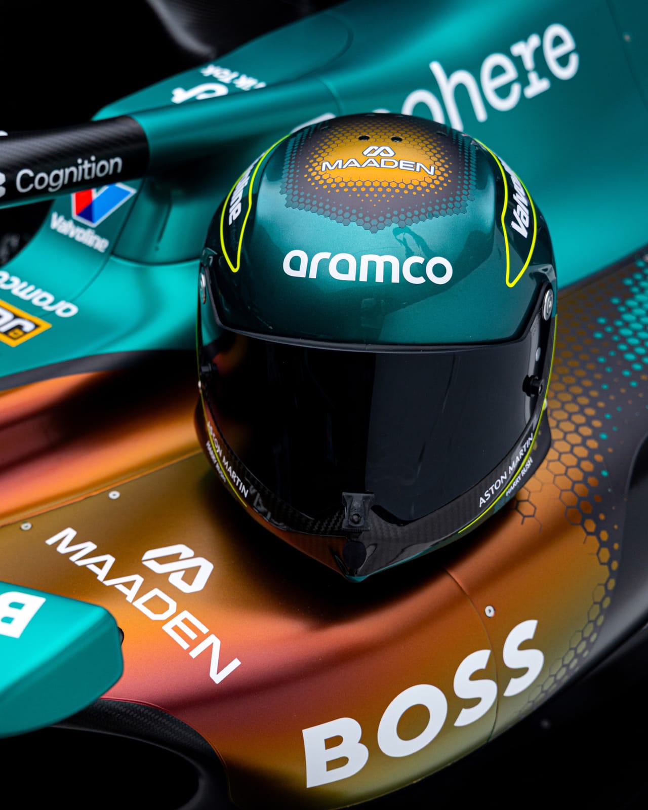 Aston Martin AMR25 F1 Monaco Grand Prix 2026 Maaden iridescent livery additional staged studio shot of the full car under dramatic lighting highlighting the color-shifting paint scheme and the layered hexagonal mesh gradient
