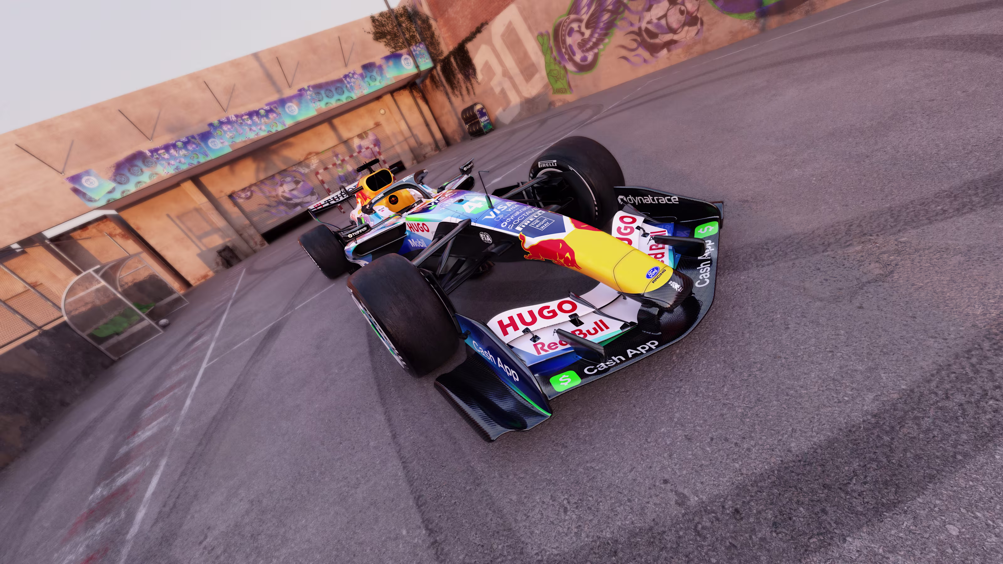 Visa Cash App Racing Bulls F1 Barcelona Grand Prix 2026 soccer football livery low front three-quarter angle of the number 41 car with the HUGO and Red Bull front wing branding, Cash App and Dynatrace endplate detail, and the spray painted soccer graffiti murals on the court walls behind the car