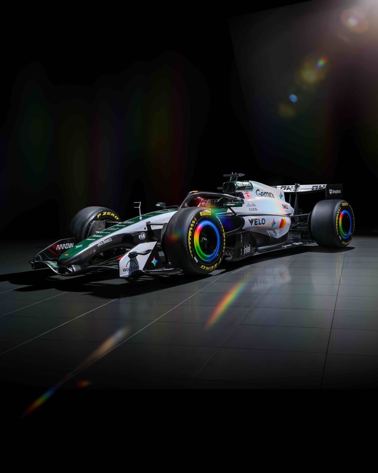 McLaren MCL40 2026 British Grand Prix special heritage livery front three-quarter studio shot showing the white body with British Racing Green accents, the green-and-white M2B throwback color split, iridescent Google Gemini detailing, and rainbow-edged wheel rims
