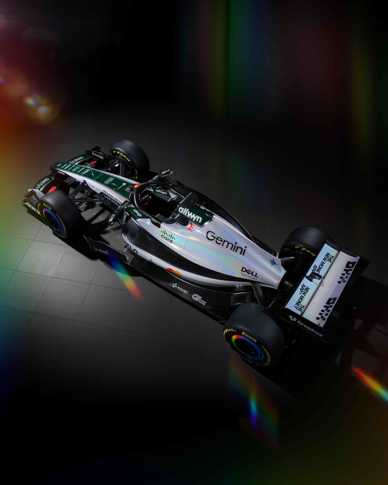 McLaren MCL40 2026 British Grand Prix heritage livery overhead three-quarter view showing the green engine cover spine running up the middle of the white car, the Gemini wordmark, and the full sponsor layout from above