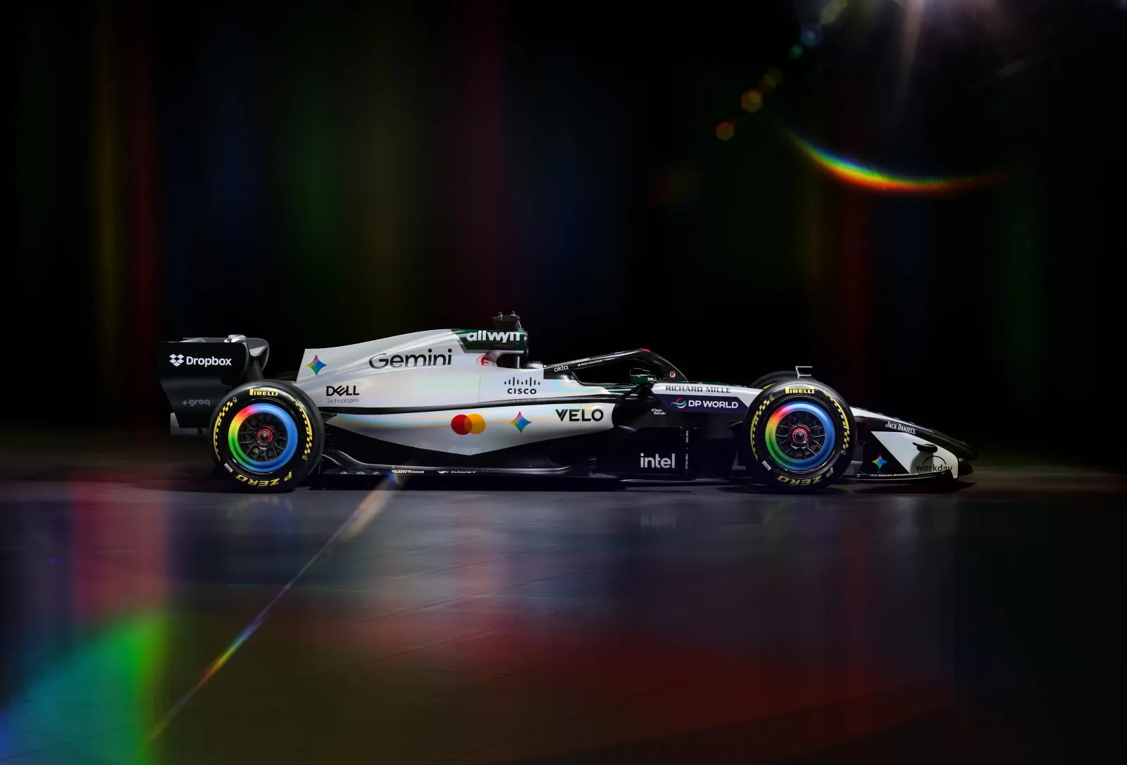 McLaren MCL40 2026 British Grand Prix heritage livery clean side profile studio shot showing the white body with the green top edge, the Gemini and VELO branding along the sidepod, and the iridescent rainbow wheel rims