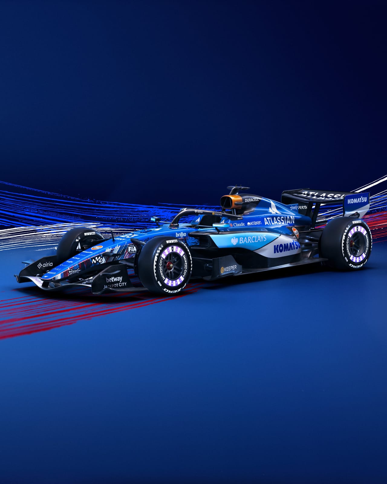 Atlassian Williams F1 2026 British Grand Prix Silverstone livery front-left three-quarter view of the blue car against a red-and-blue airflow backdrop