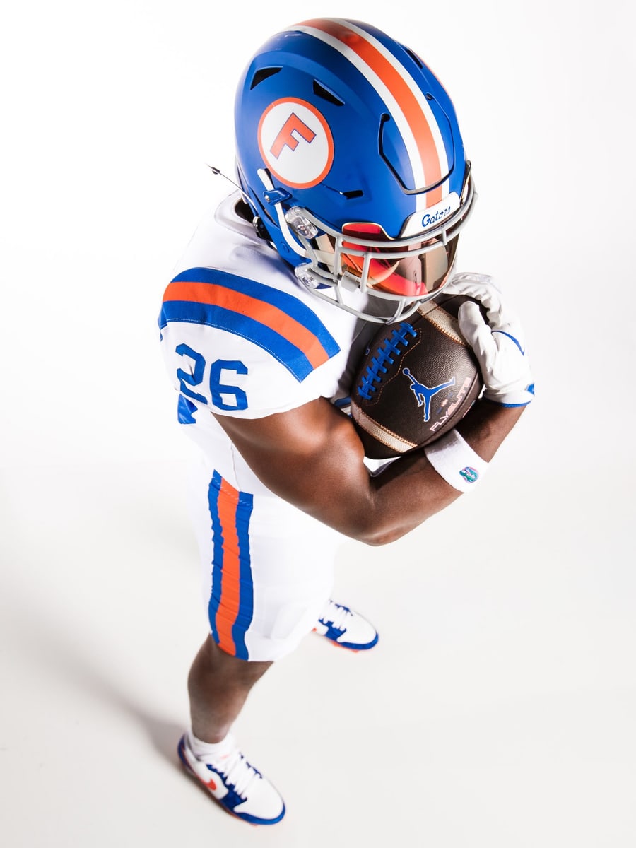 Overhead view of the Florida Gators 2026 throwback jersey showing the blue and orange shoulder stripes and the pant outseam striping