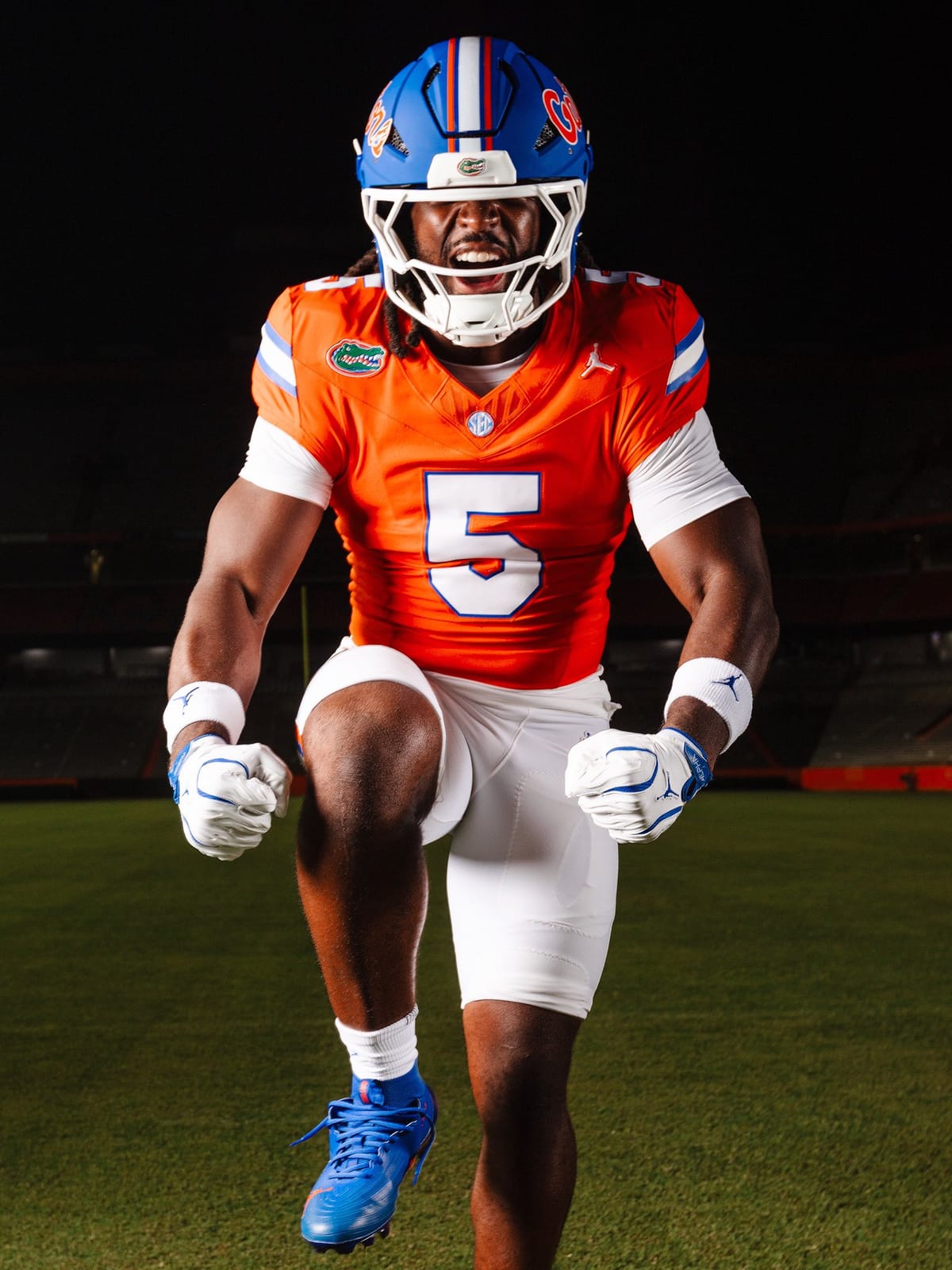 Front view of the Florida Gators orange jersey and white pants combination with white block numbers outlined in blue