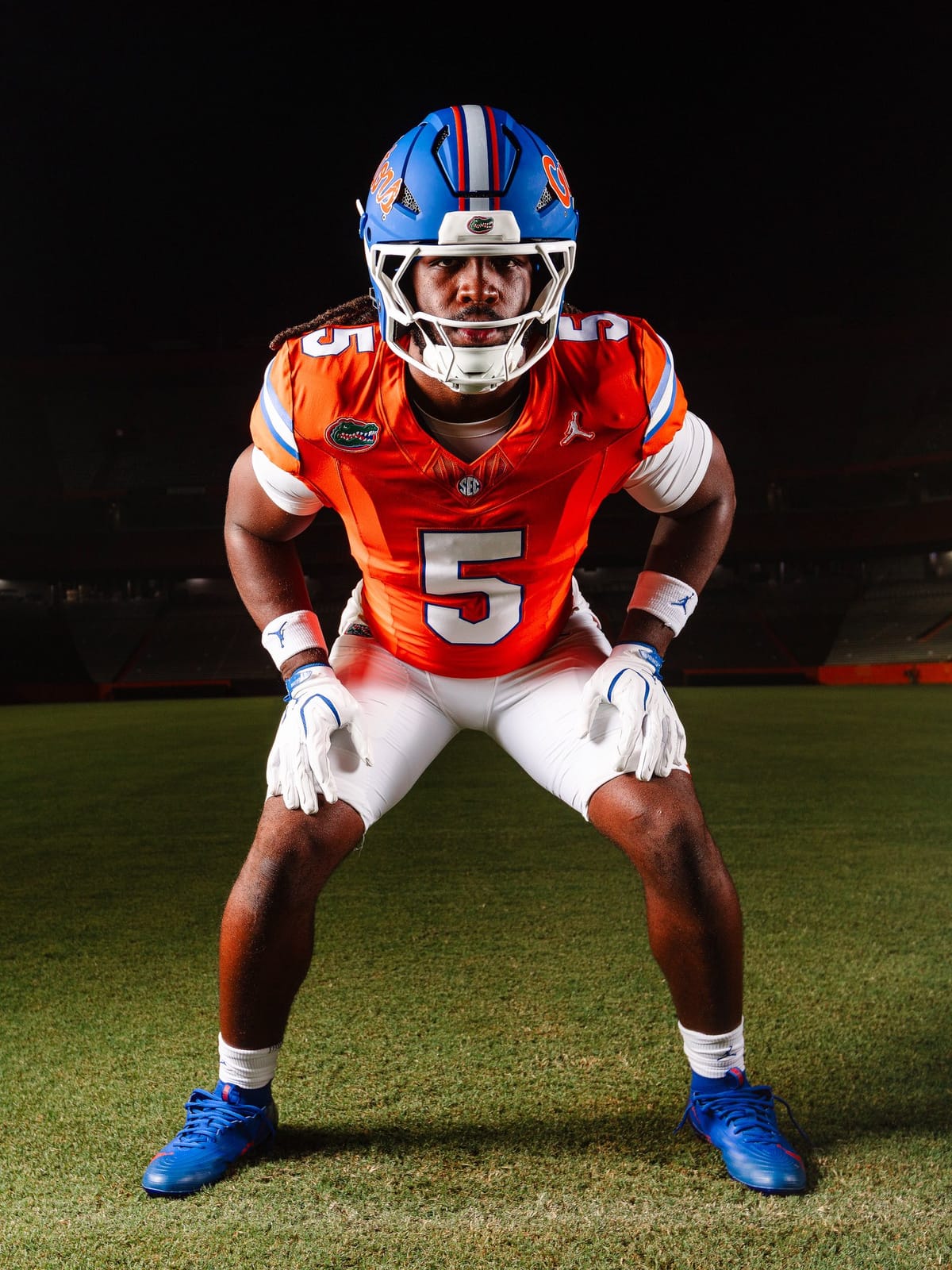 Florida Gators 2026 uniform combination with a matte blue helmet carrying the orange Gators script, an orange jersey with white numbers and blue and white shoulder stripes, and white pants
