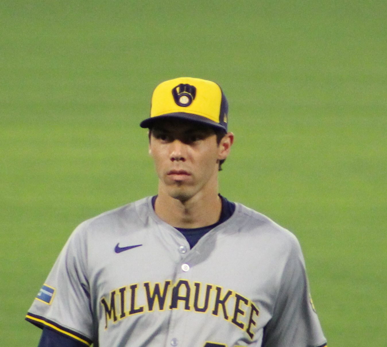 Christian Yelich in the Brewers' gray road uniform with the navy-and-gold ball-in-glove logo on the front of his cap, in left field at Angel Stadium, June 18, 2024