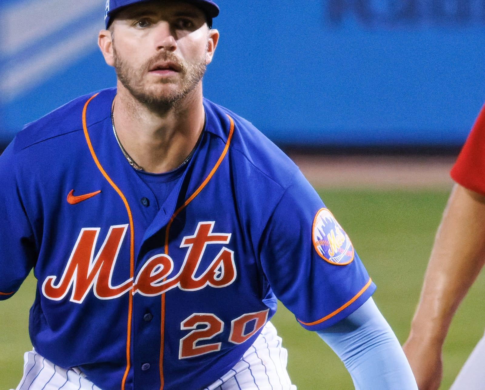Pete Alonso in the Mets' royal blue jersey with the round skyline-and-bridge Mets logo patch on his left sleeve, playing first base during a spring training game against the Cardinals, March 25, 2023