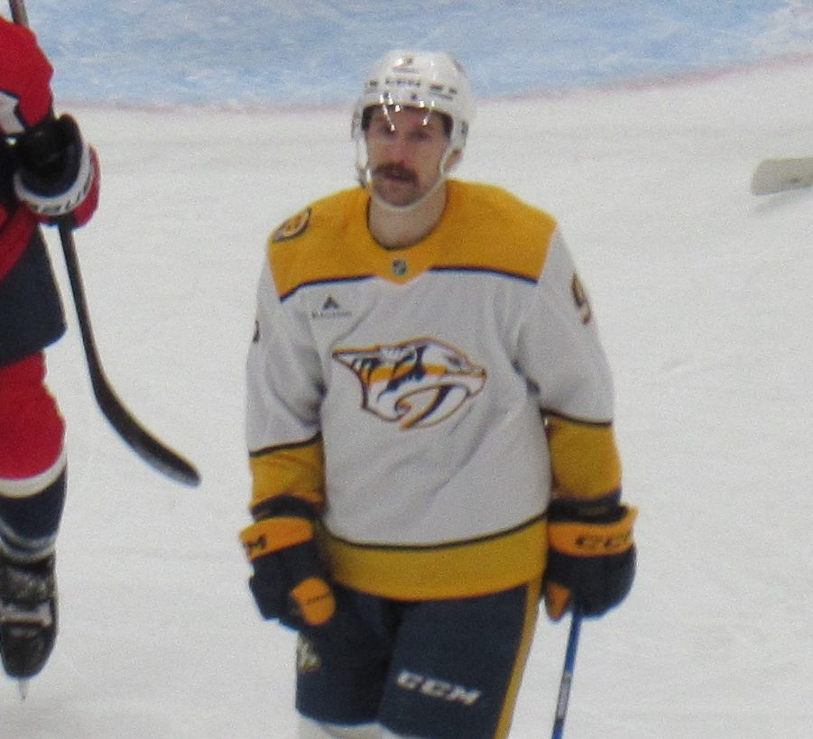 Filip Forsberg in the Predators' white road sweater with the gold saber-toothed cat crest on the chest, during a game against the Capitals in Washington, February 5, 2026