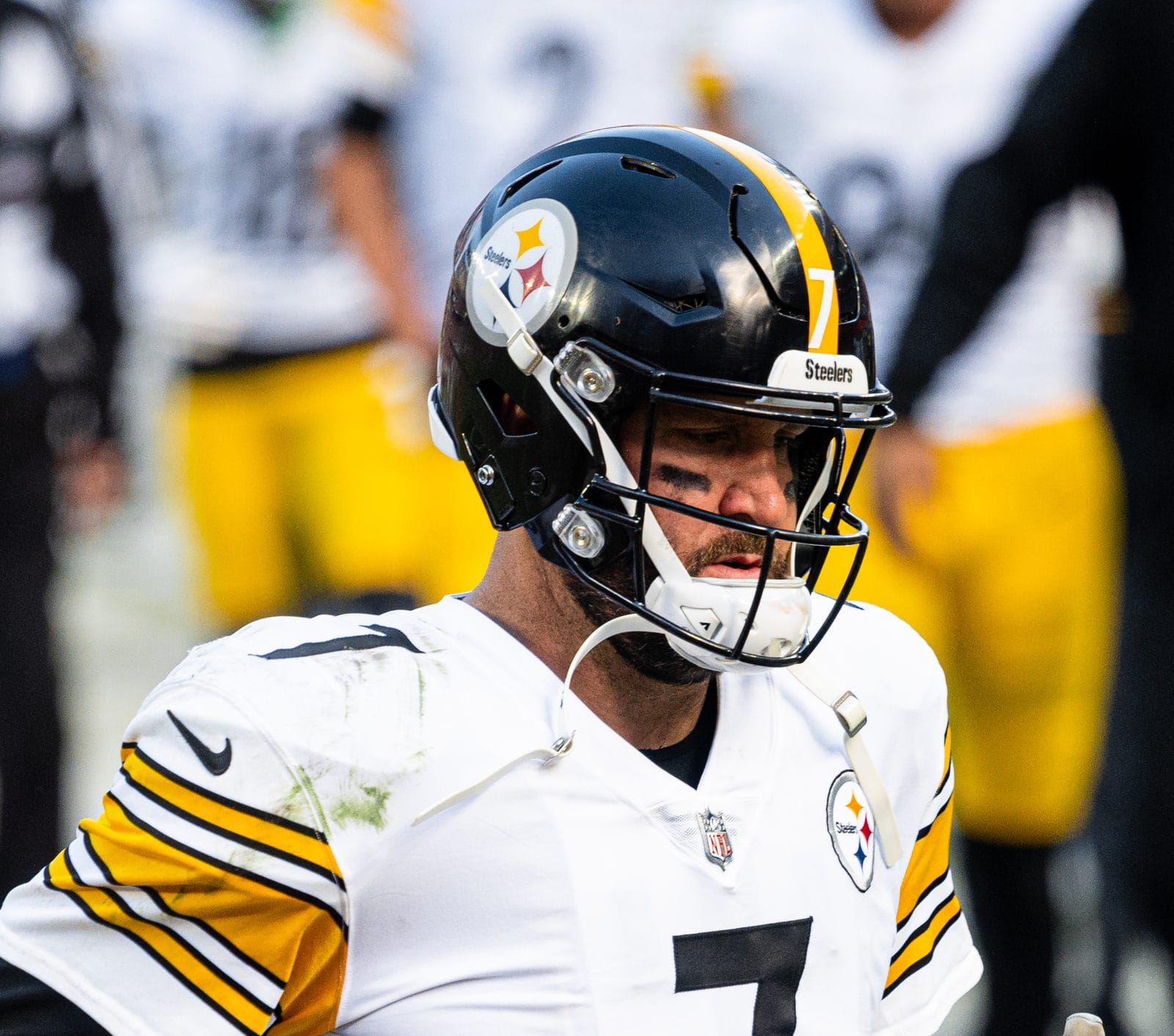 Ben Roethlisberger in the Steelers' white road uniform with the yellow, orange and blue Steelmark on the side of his black helmet, against the Browns in Cleveland, October 31, 2021