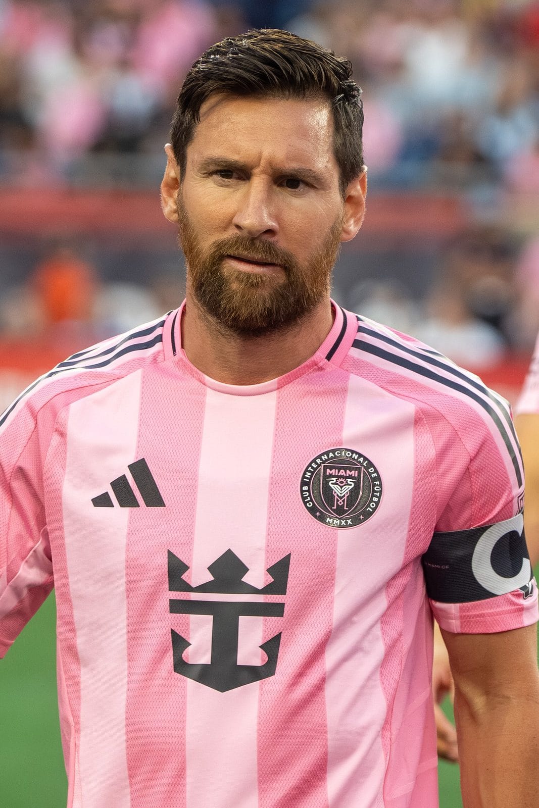 Lionel Messi in Inter Miami's pink home kit, with the crest's two herons and their M-shaped legs on the chest, at Gillette Stadium on July 9, 2025