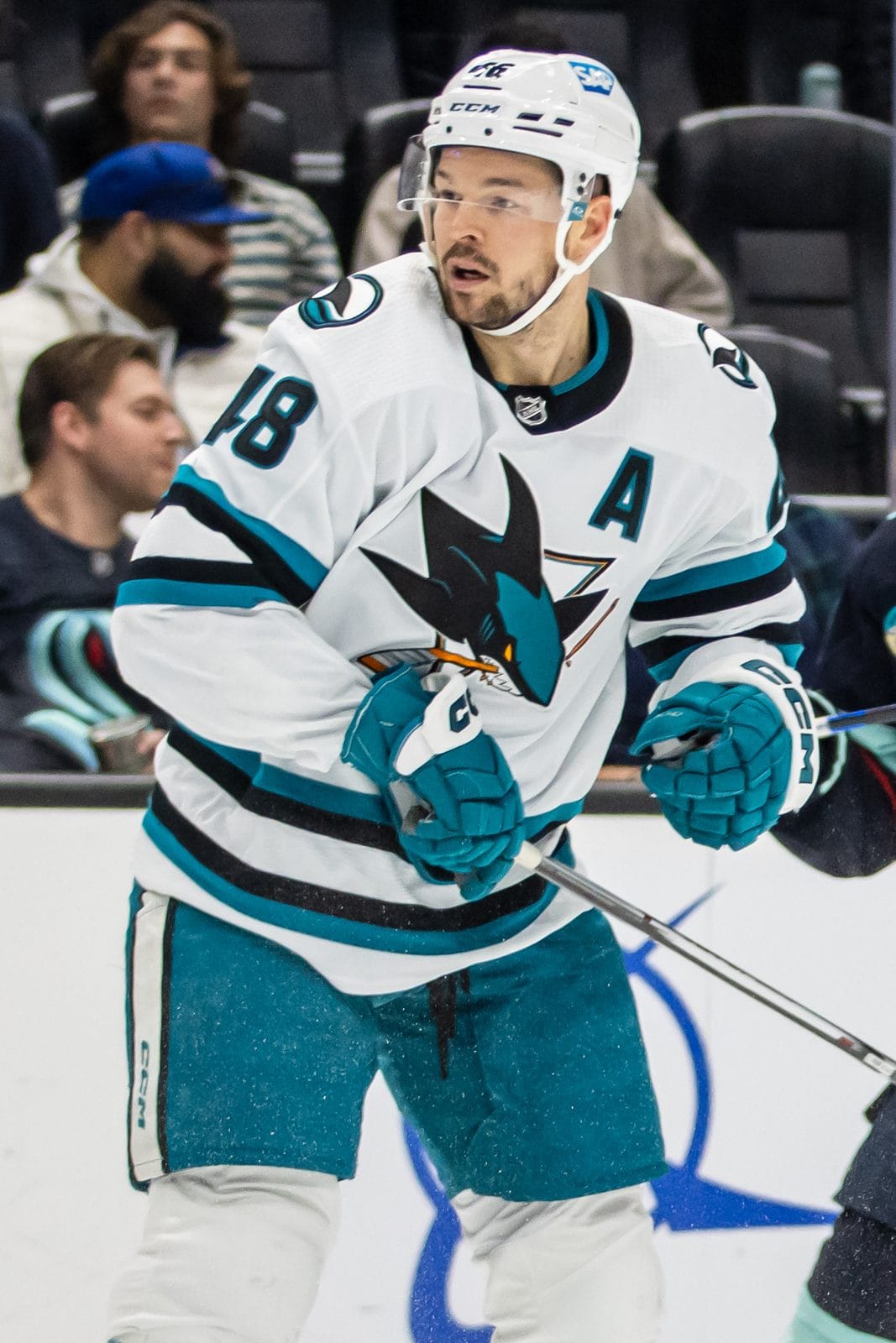 Sharks forward Tomas Hertl in the white road jersey, showing the shark biting a stick in front of the triangle, in Seattle on Nov. 22, 2023
