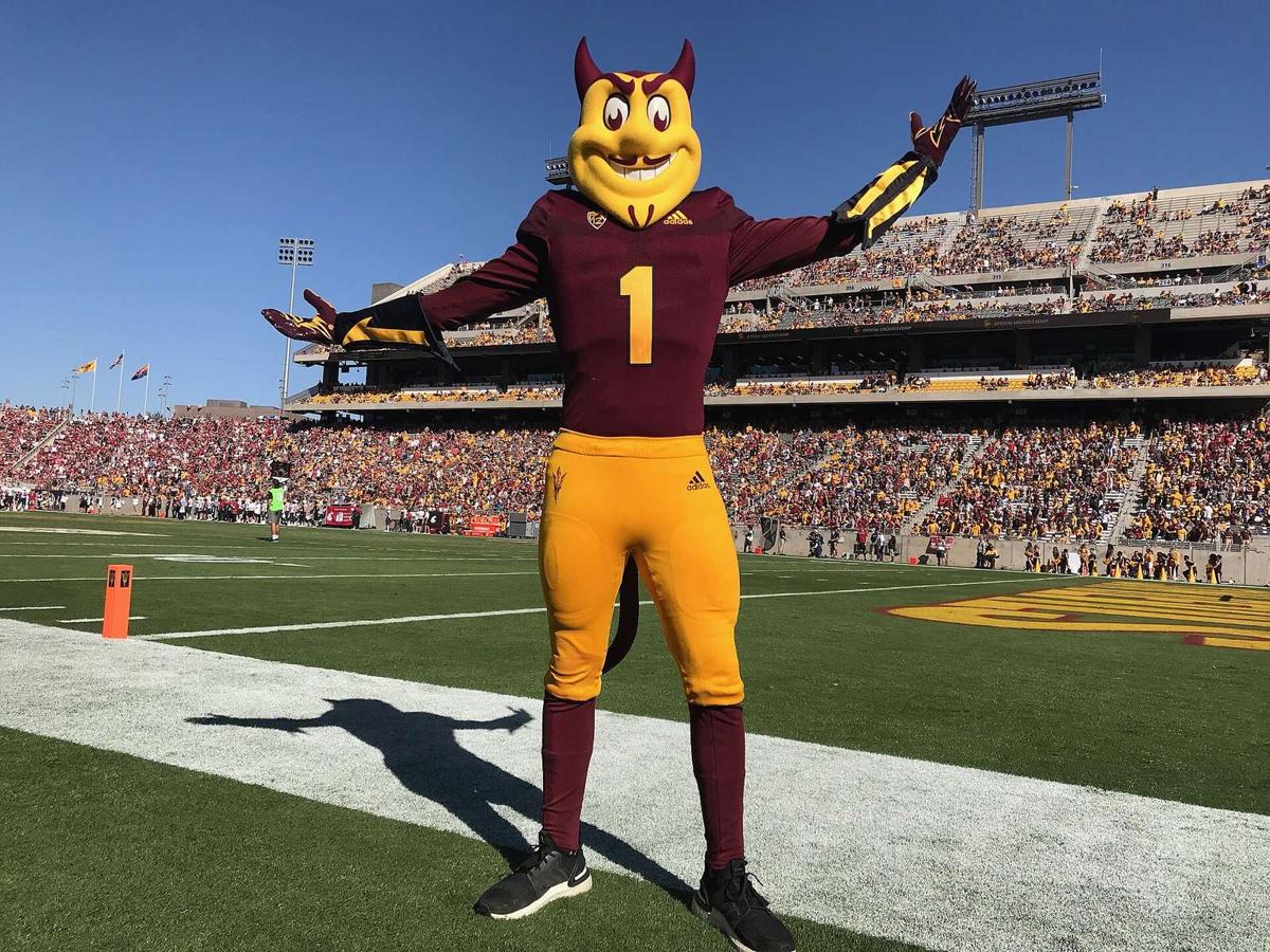 Sparky the Sun Devil mascot in a maroon No. 1 jersey with gold pants, arms out on the sideline at an Arizona State football game in 2019