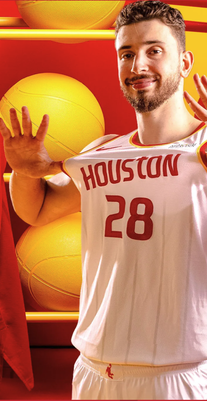 Houston Rockets 2026-27 Association Edition white home jersey worn by Reed Sheppard in a studio shot, with red HOUSTON wordmark, Championship Yellow trim around the collar and arm holes, Memorial Hermann sponsor patch, and the Speed Pattern subtle pinstripes throughout
