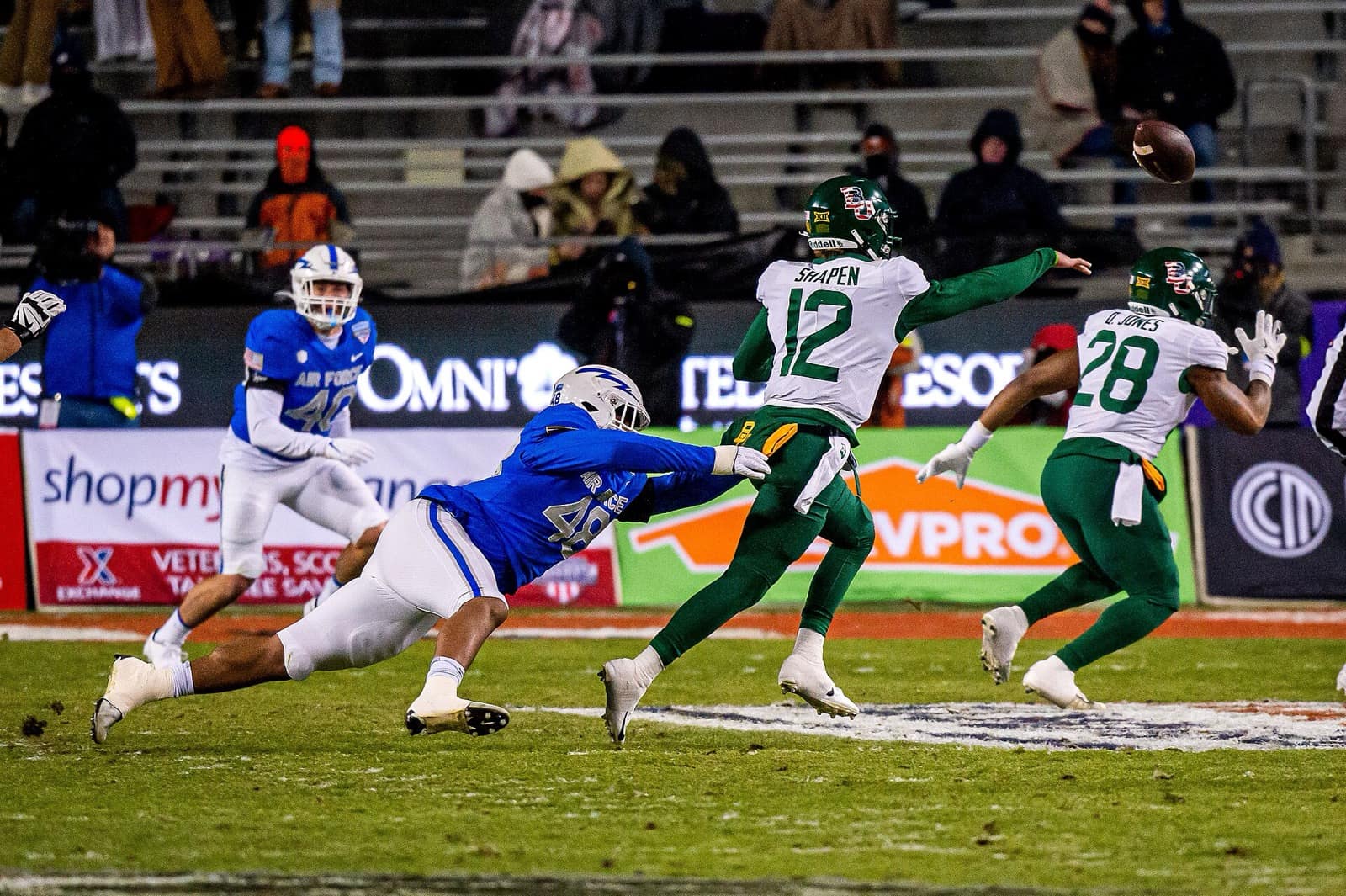 Baylor quarterback Blake Shapen throws in a white jersey, green pants and green helmet at the 2022 Armed Forces Bowl