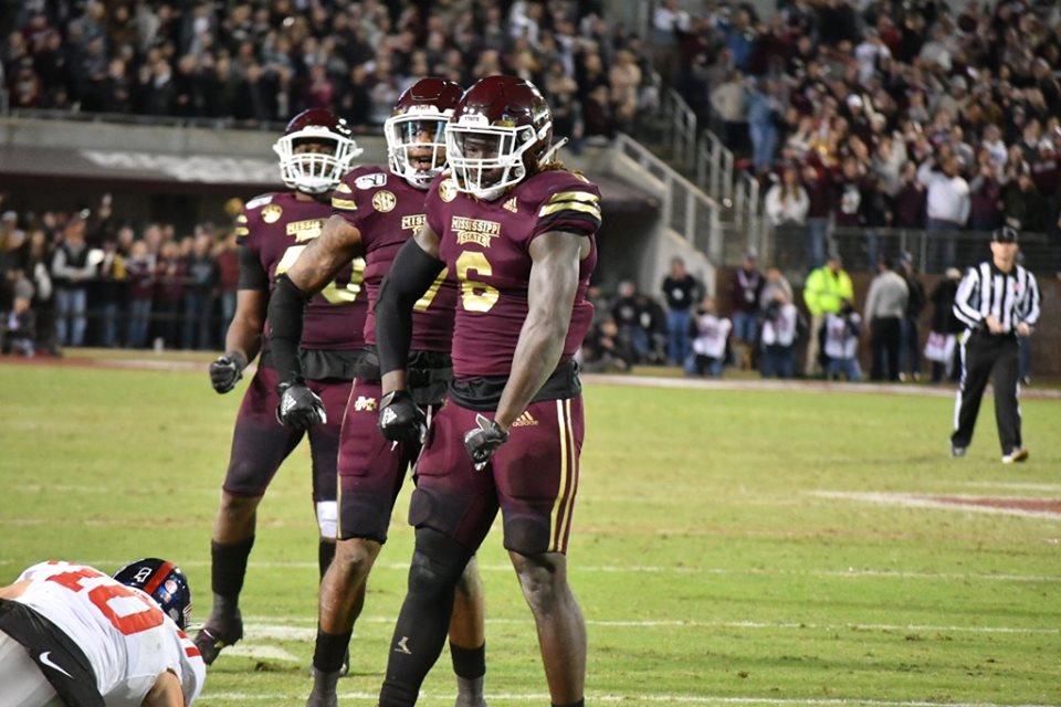 Mississippi State players in maroon home jerseys and maroon helmets on the field during the 2019 Egg Bowl