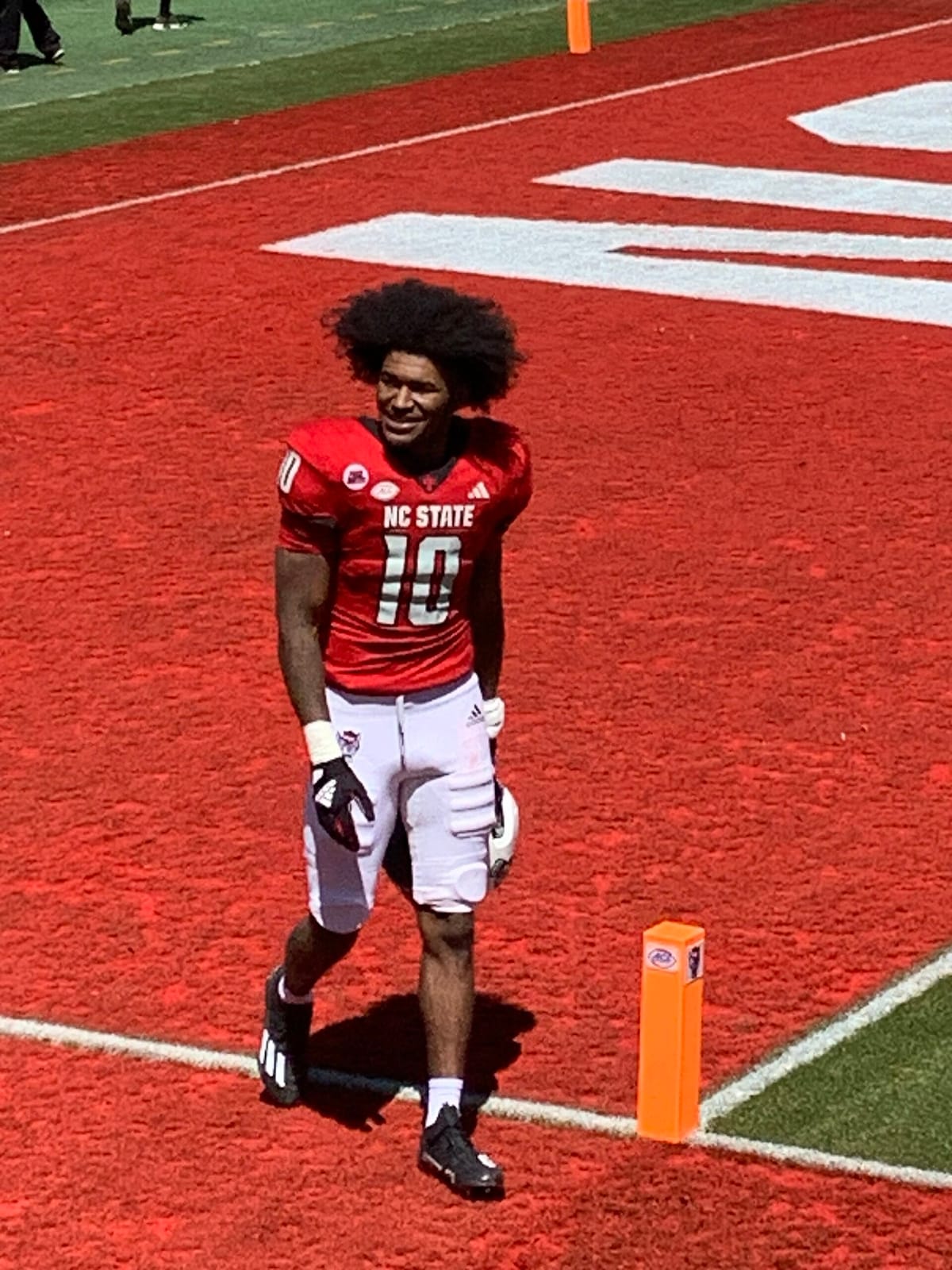 NC State receiver Kevin Concepcion in the red home jersey stands in the end zone at Carter-Finley Stadium