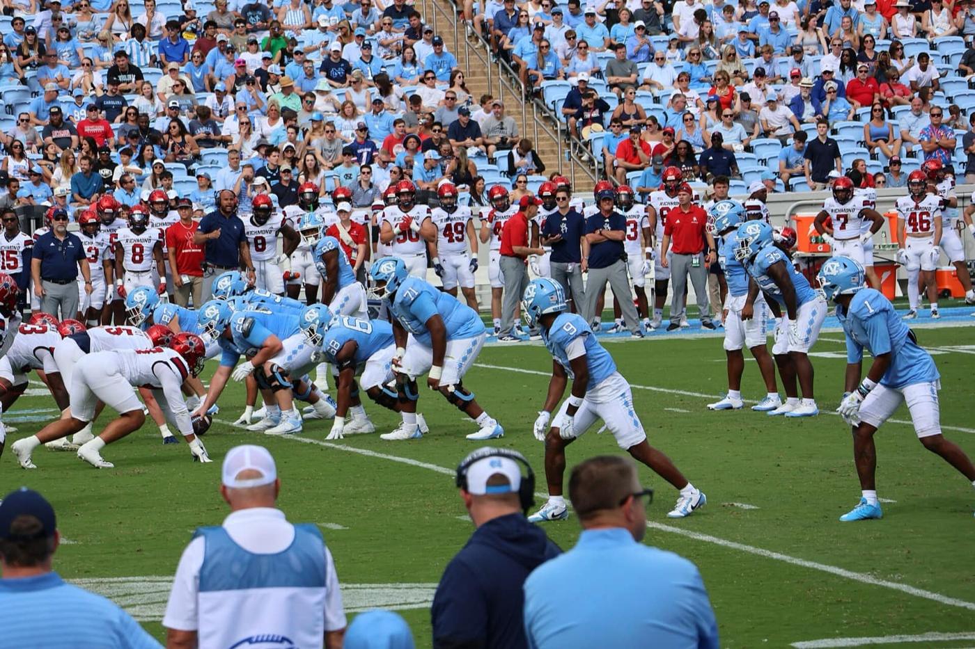 North Carolina in Carolina blue jerseys at the line against Richmond at Kenan Stadium