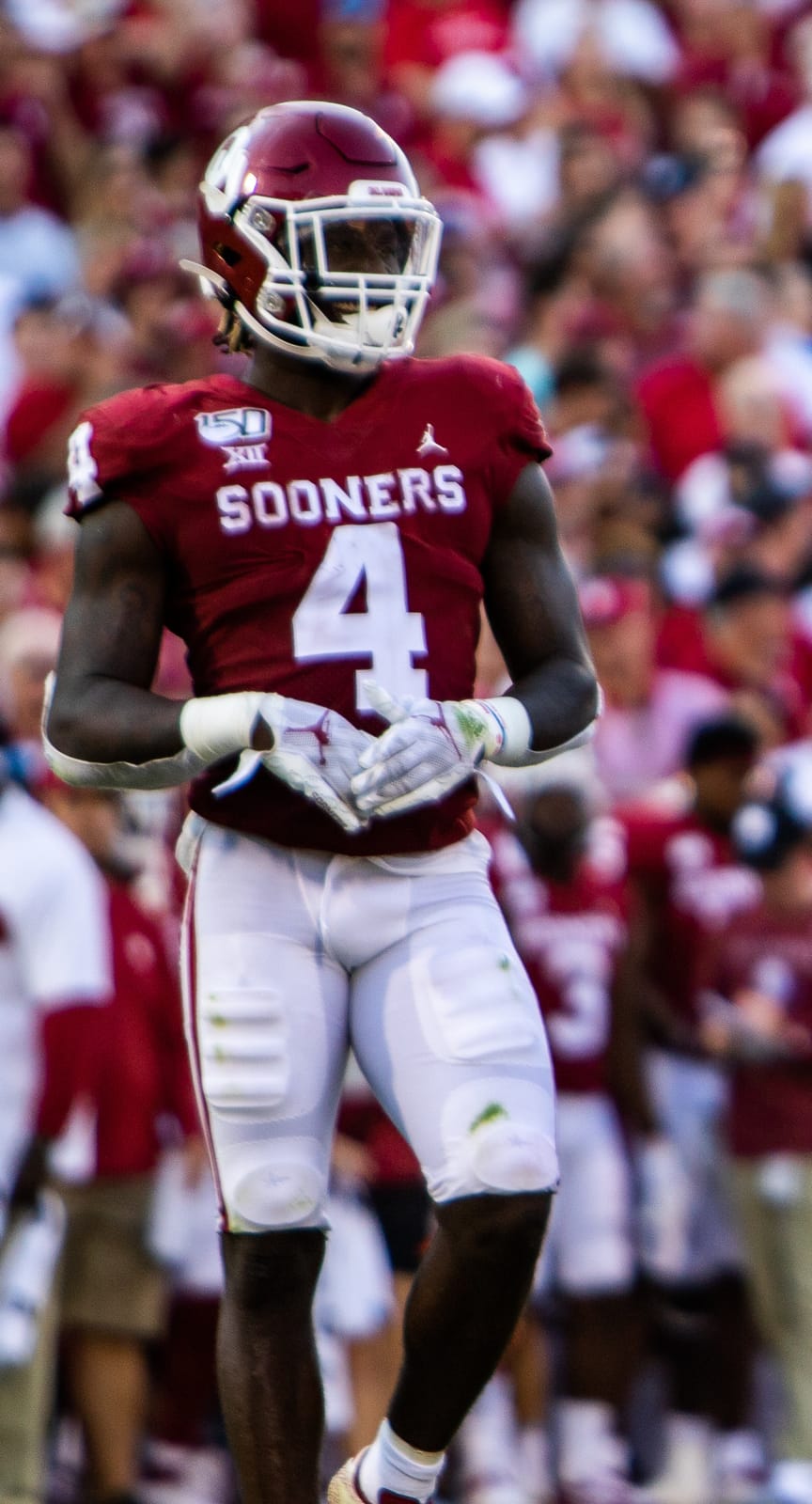 Oklahoma running back Trey Sermon in the crimson home jersey with the SOONERS chest wordmark and crimson helmet