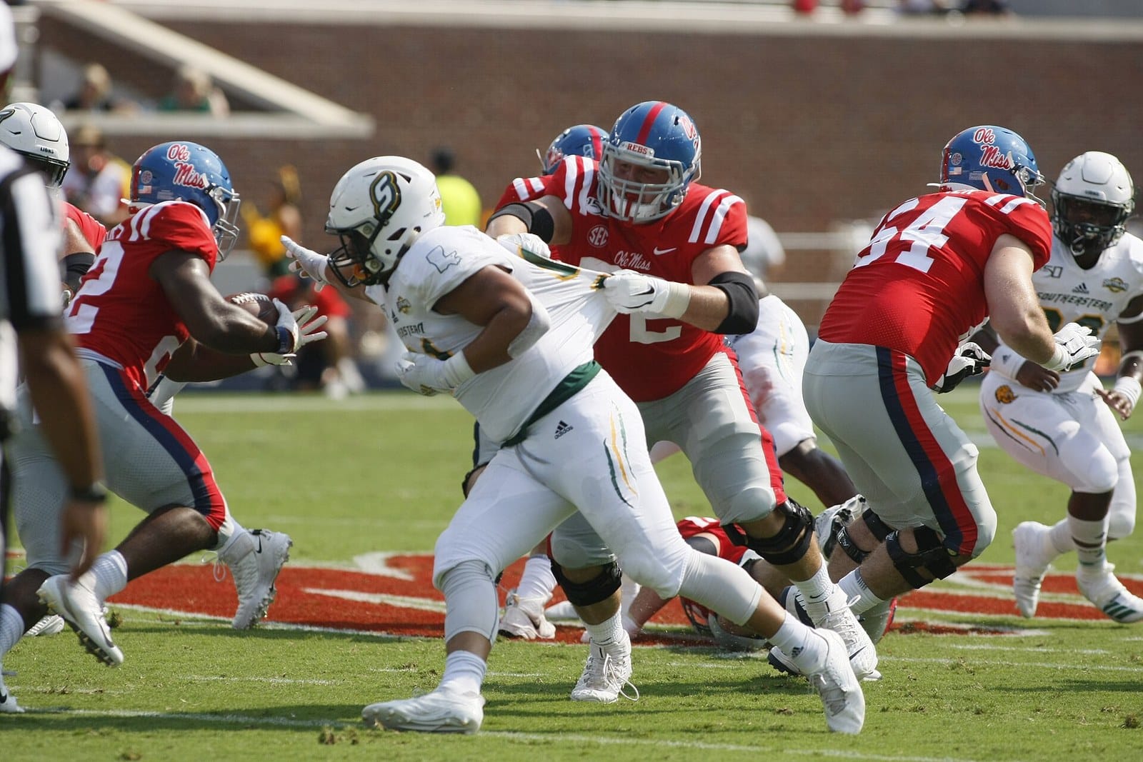 Ole Miss players in red jerseys, navy helmets and navy pants against Southeastern Louisiana at Vaught-Hemingway Stadium