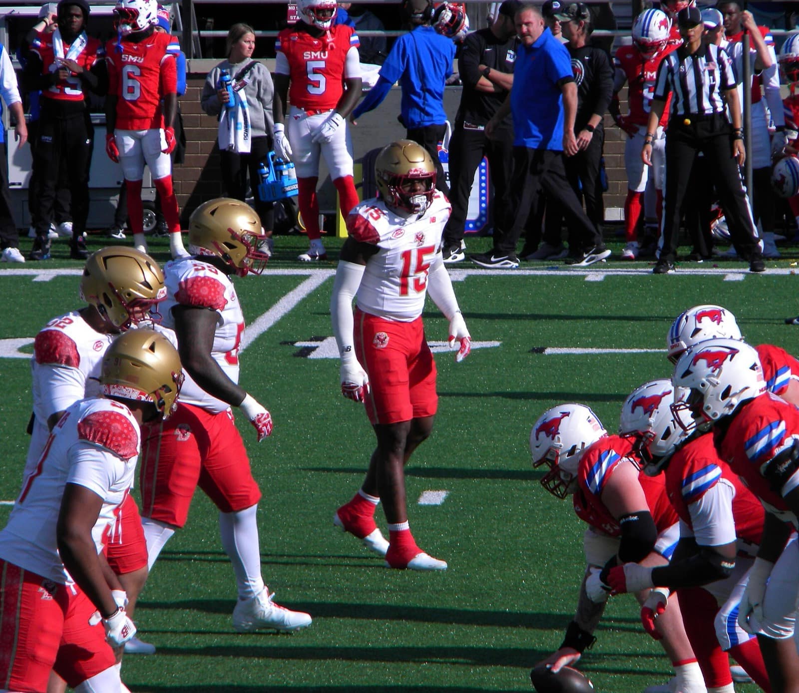 SMU's offense in red jerseys and white helmets at the line against Boston College in November 2025