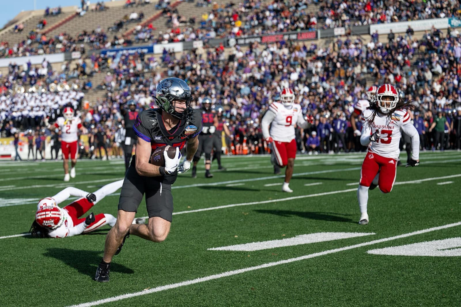 TCU receiver Blake Nowell runs with the ball in TCU's black alternate uniform at the 2024 New Mexico Bowl