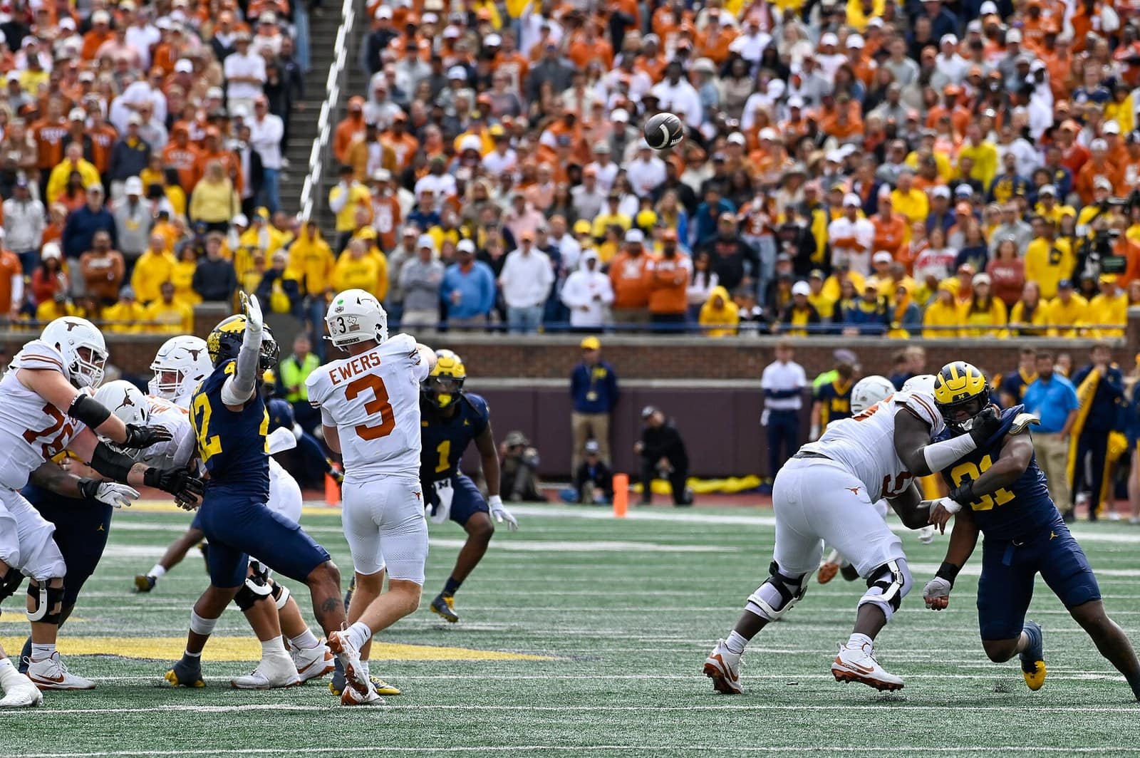 Texas quarterback Quinn Ewers and the Longhorns in all-white road uniforms against Michigan at Michigan Stadium