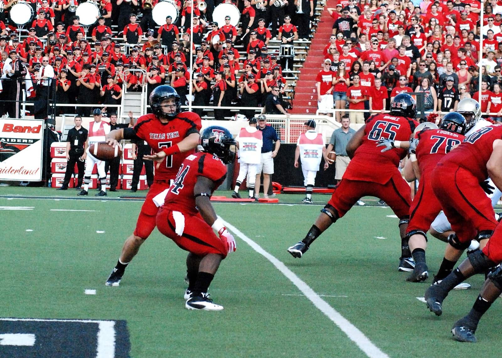 Texas Tech quarterback Seth Doege drops back in a red jersey, black pants and black helmet in 2011