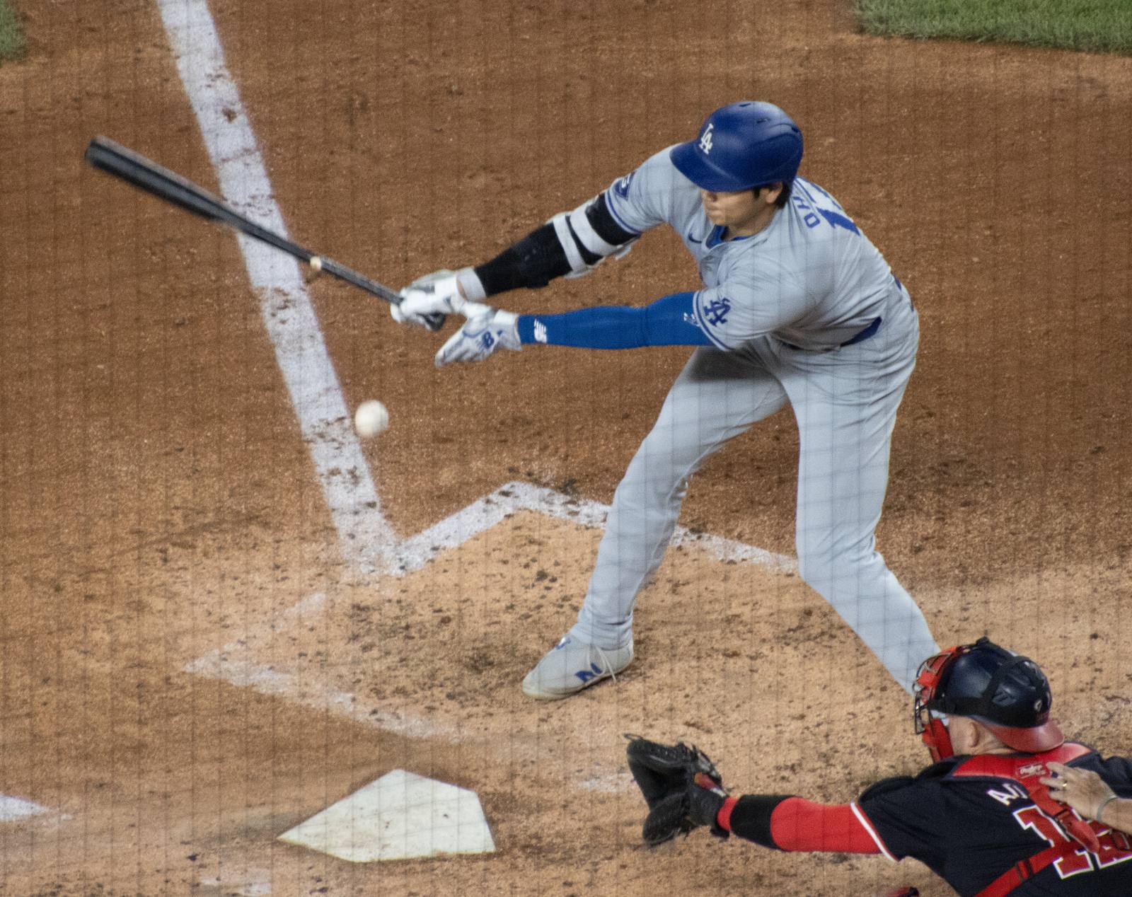 Shohei Ohtani swings in the Dodgers' road gray uniform and blue helmet