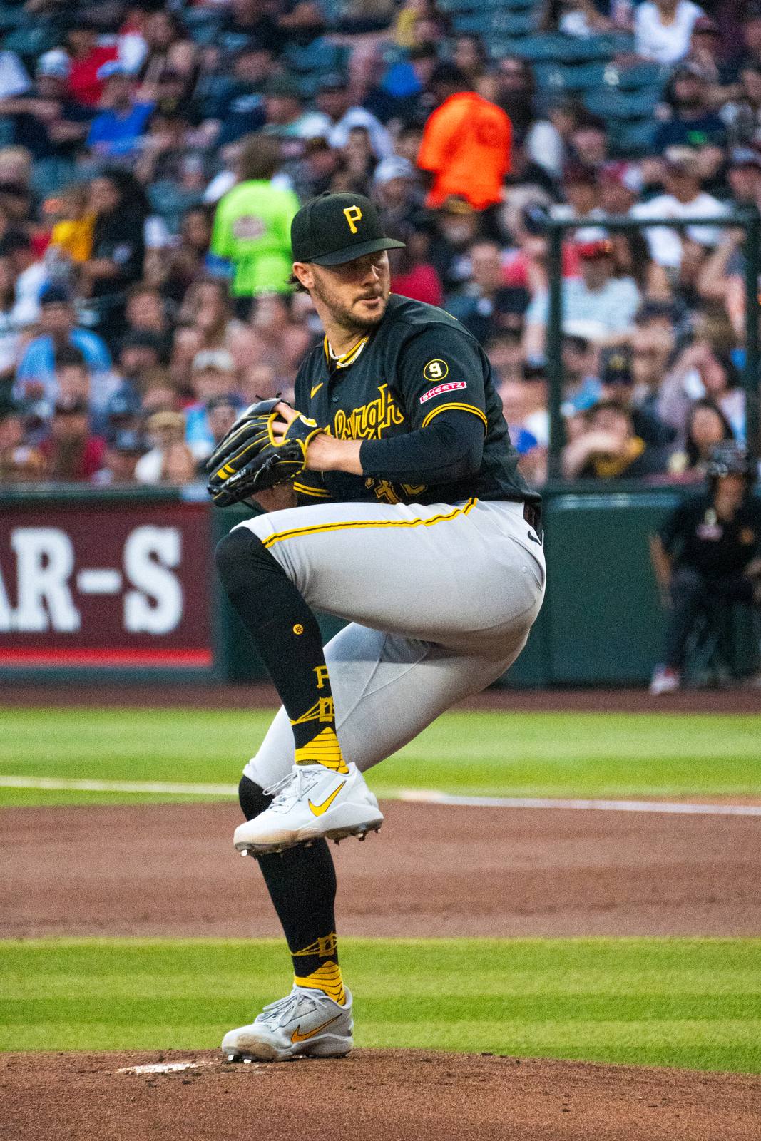 Paul Skenes mid-windup in the Pirates' black Pittsburgh alternate jersey and gray pants