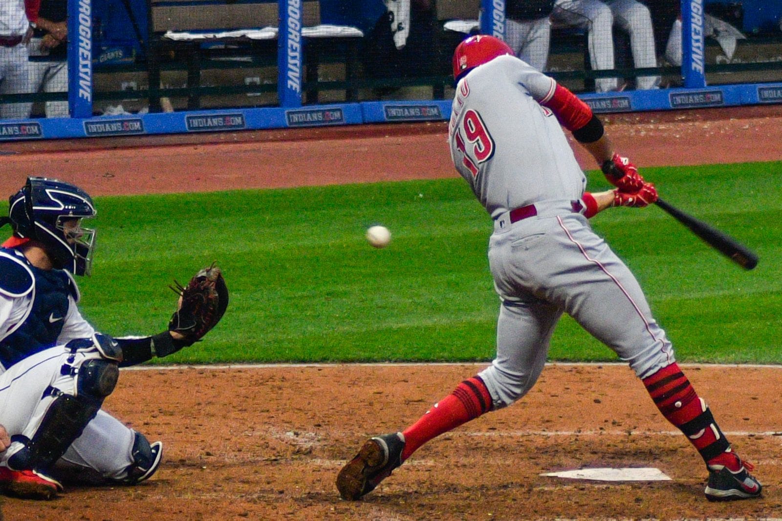 Joey Votto swings in the Reds' road gray uniform