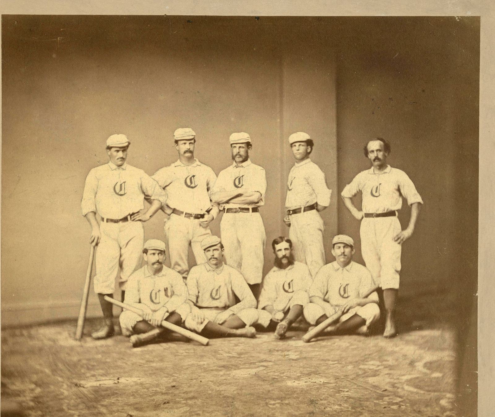 The 1869 Cincinnati Red Stockings posed in uniforms with an Old English C