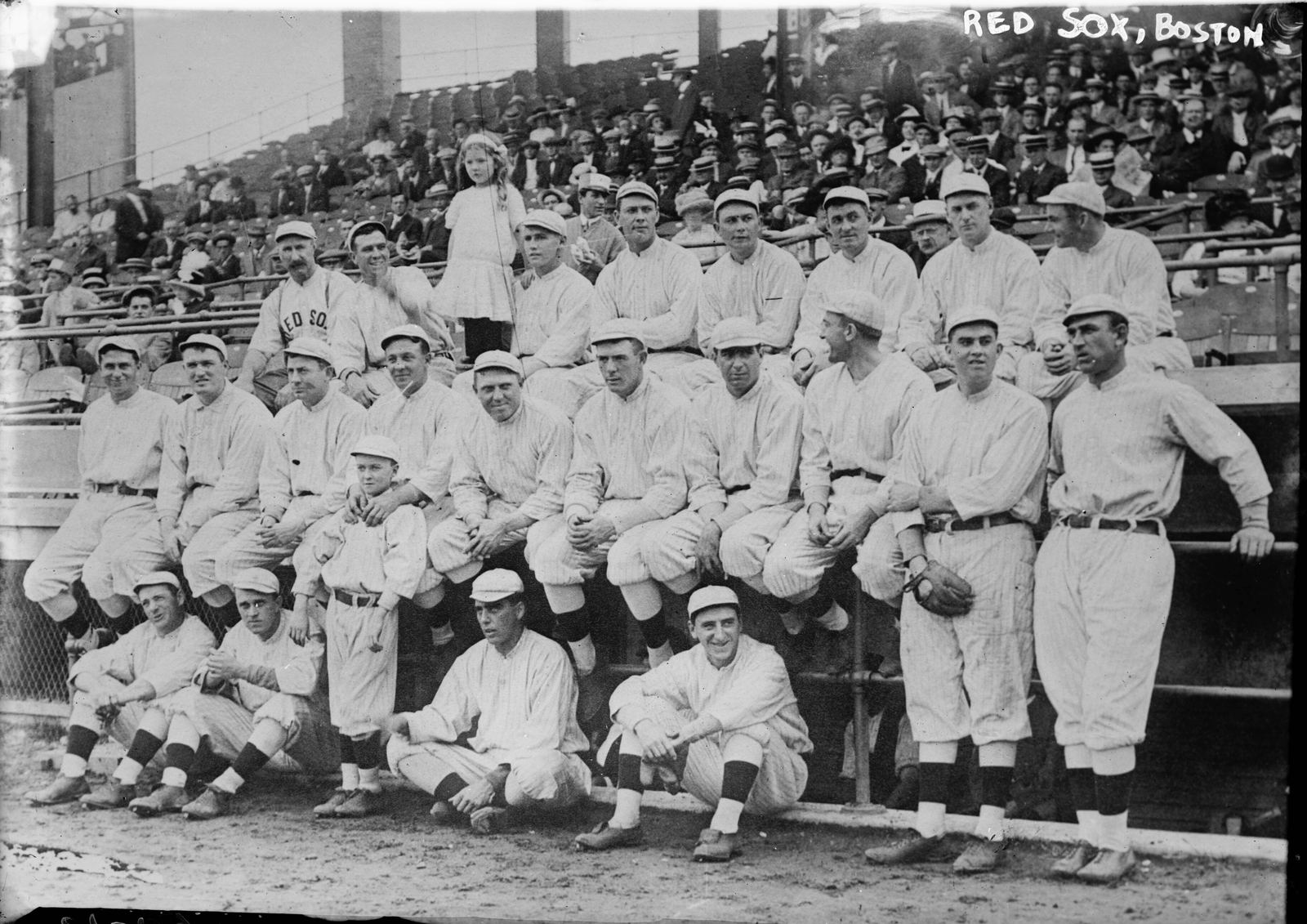 The 1912 Boston Red Sox pose in front of the grandstand in white uniforms at the World Series
