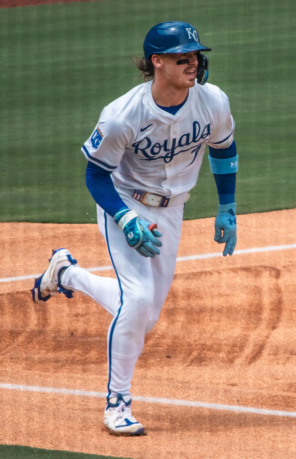 Bobby Witt Jr. runs in the Royals' white home uniform with blue Royals script