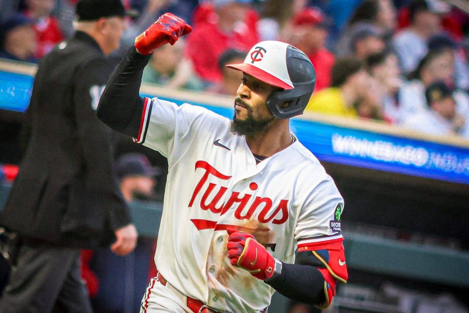 Byron Buxton celebrates in the Twins' white home jersey with red Twins script