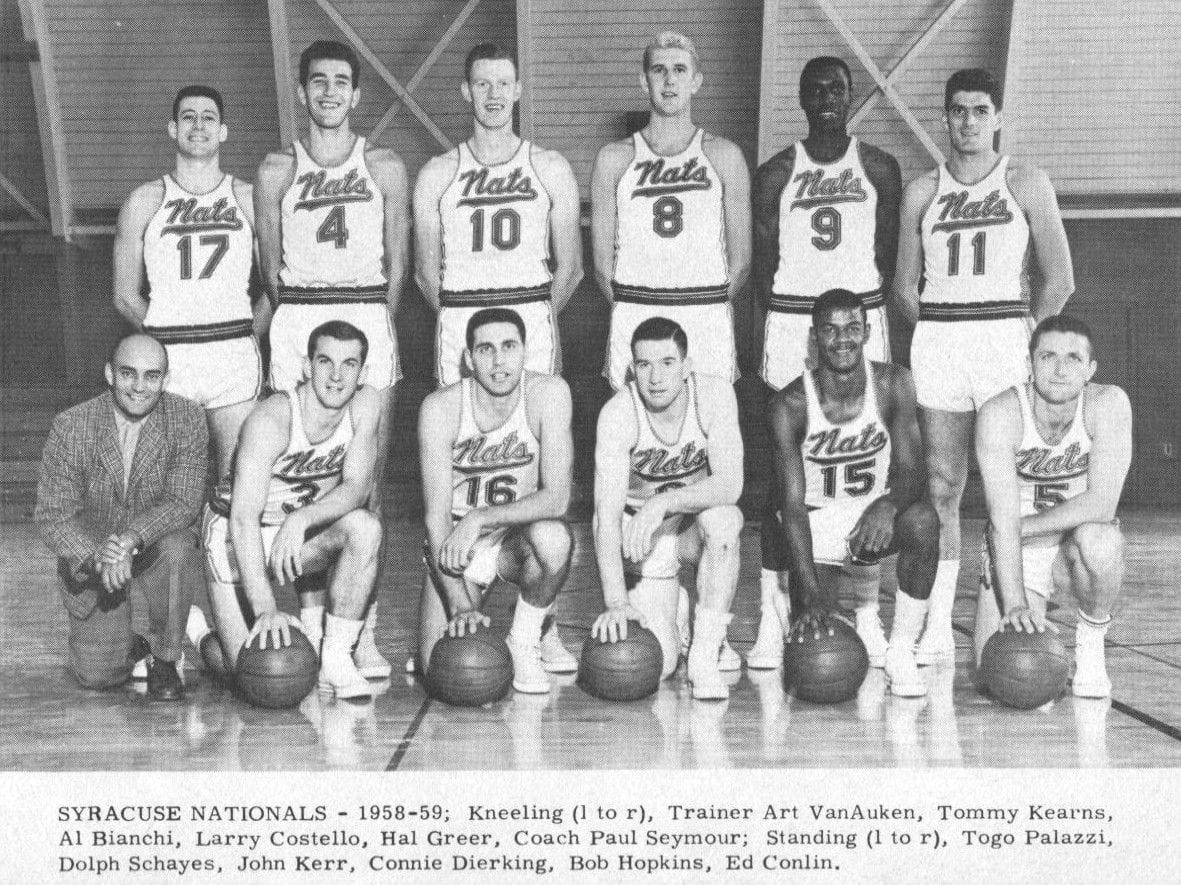 The 1958-59 Syracuse Nationals team photo in white NATS uniforms, with Dolph Schayes, Hal Greer and coach Paul Seymour named in the caption
